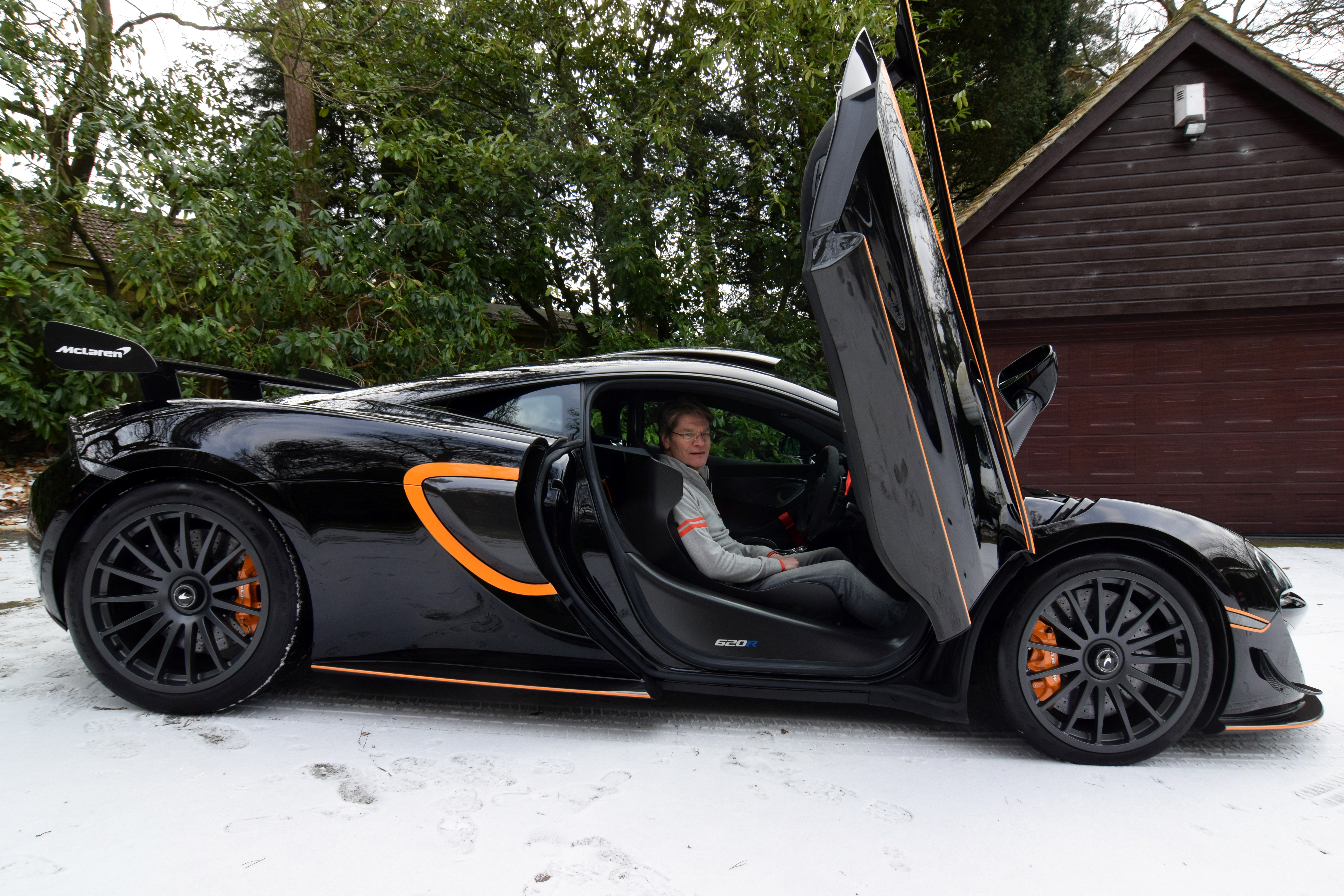 Glynn sits in his most recently acquired McLaren at his home in Headley Down
