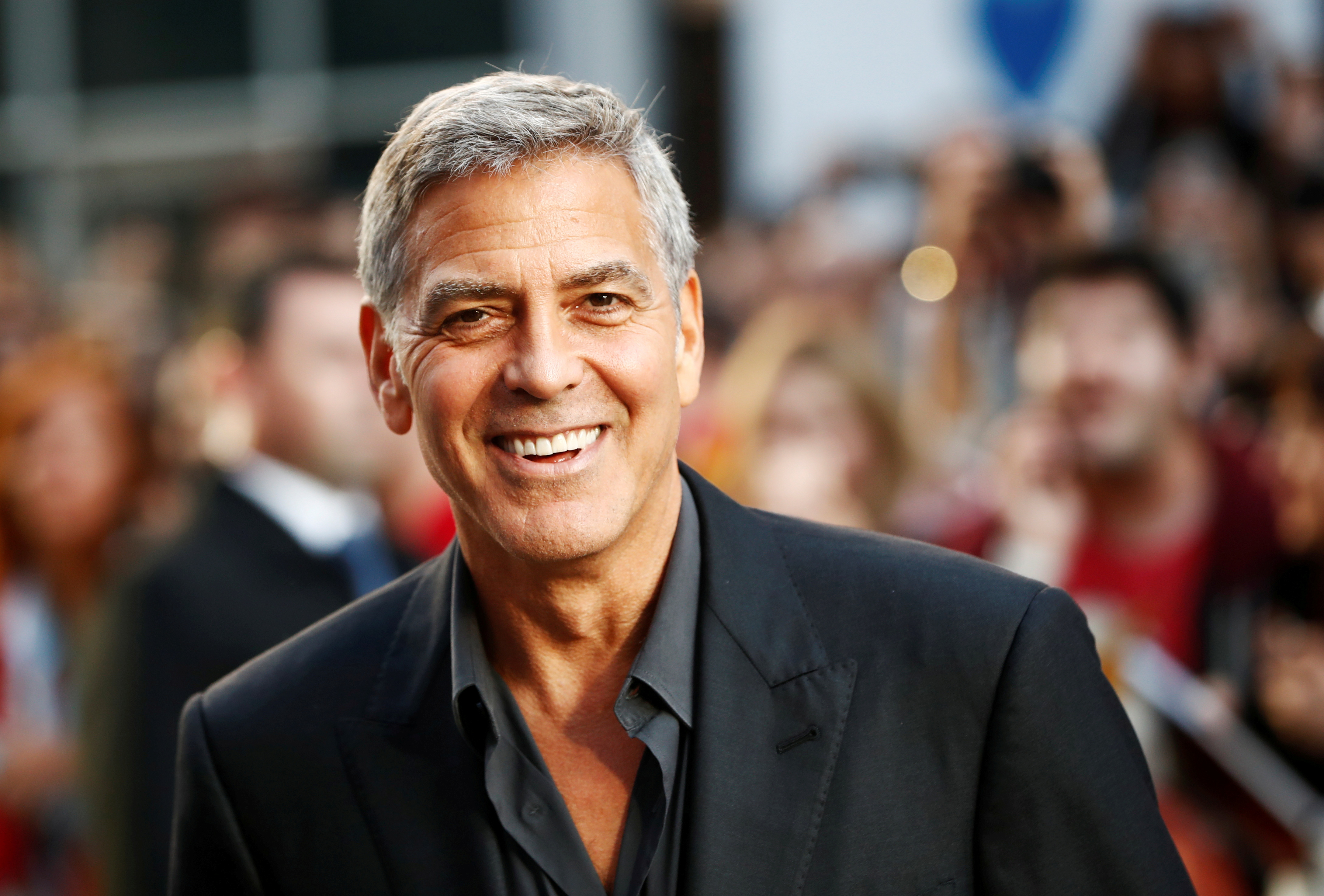 Clooney arrives on the red carpet for the film 