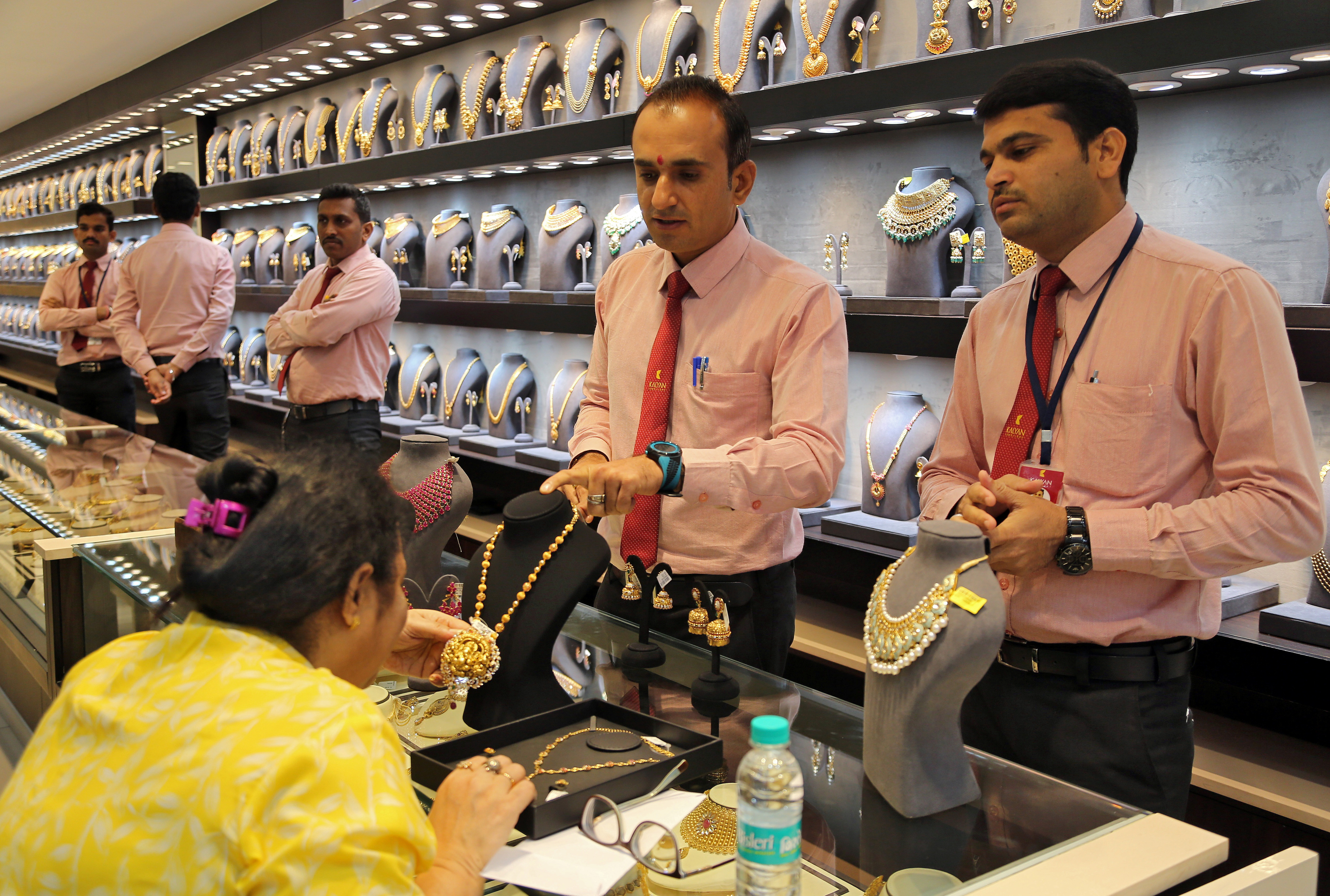 A customer checks a gold necklace before buying it inside a jewellery showroom on the occasion of Akshaya Tritiya, a major gold buying festival, in Mumbai