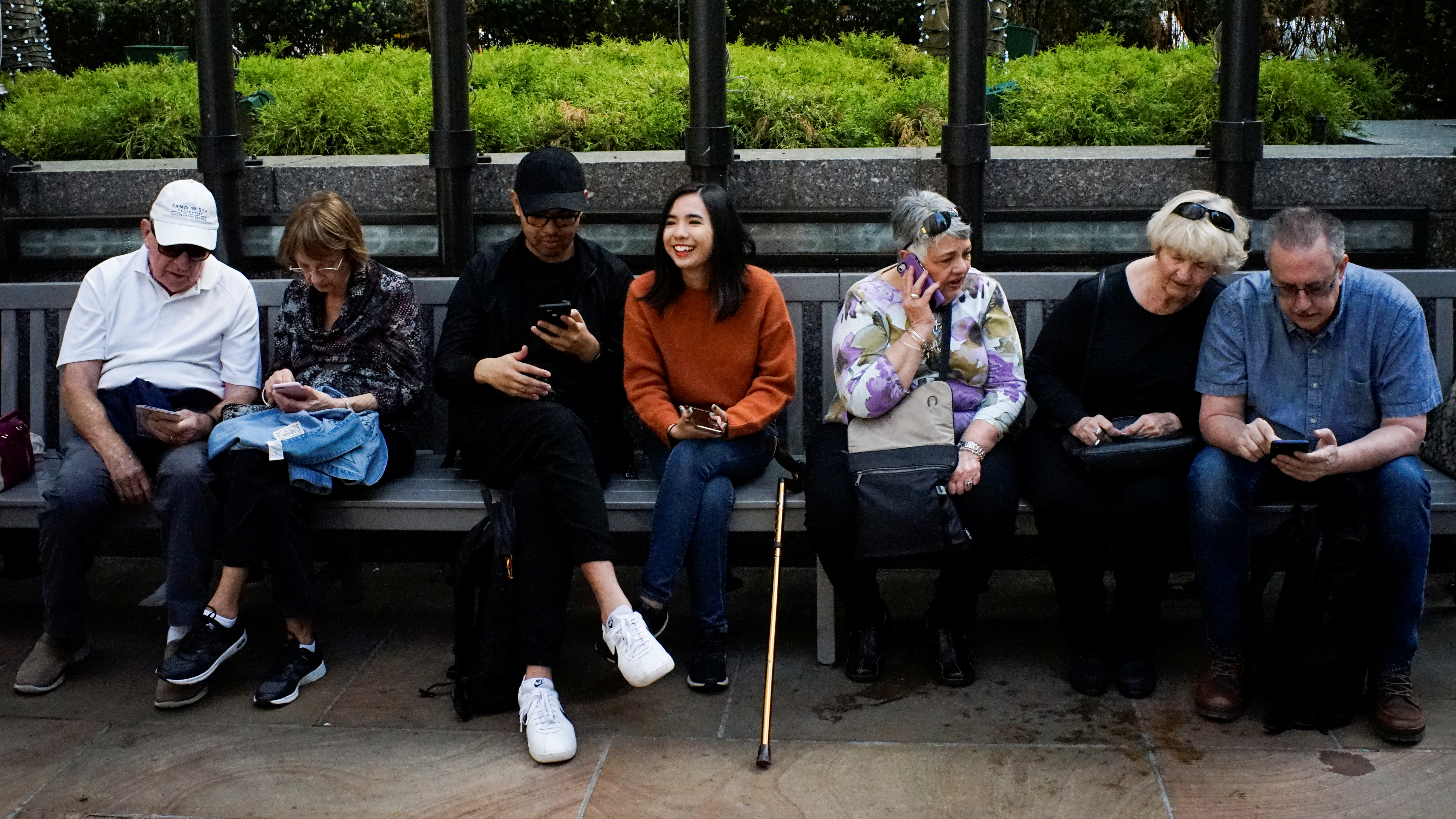 People look at their smartphones at the Rockefeller center in New York City
