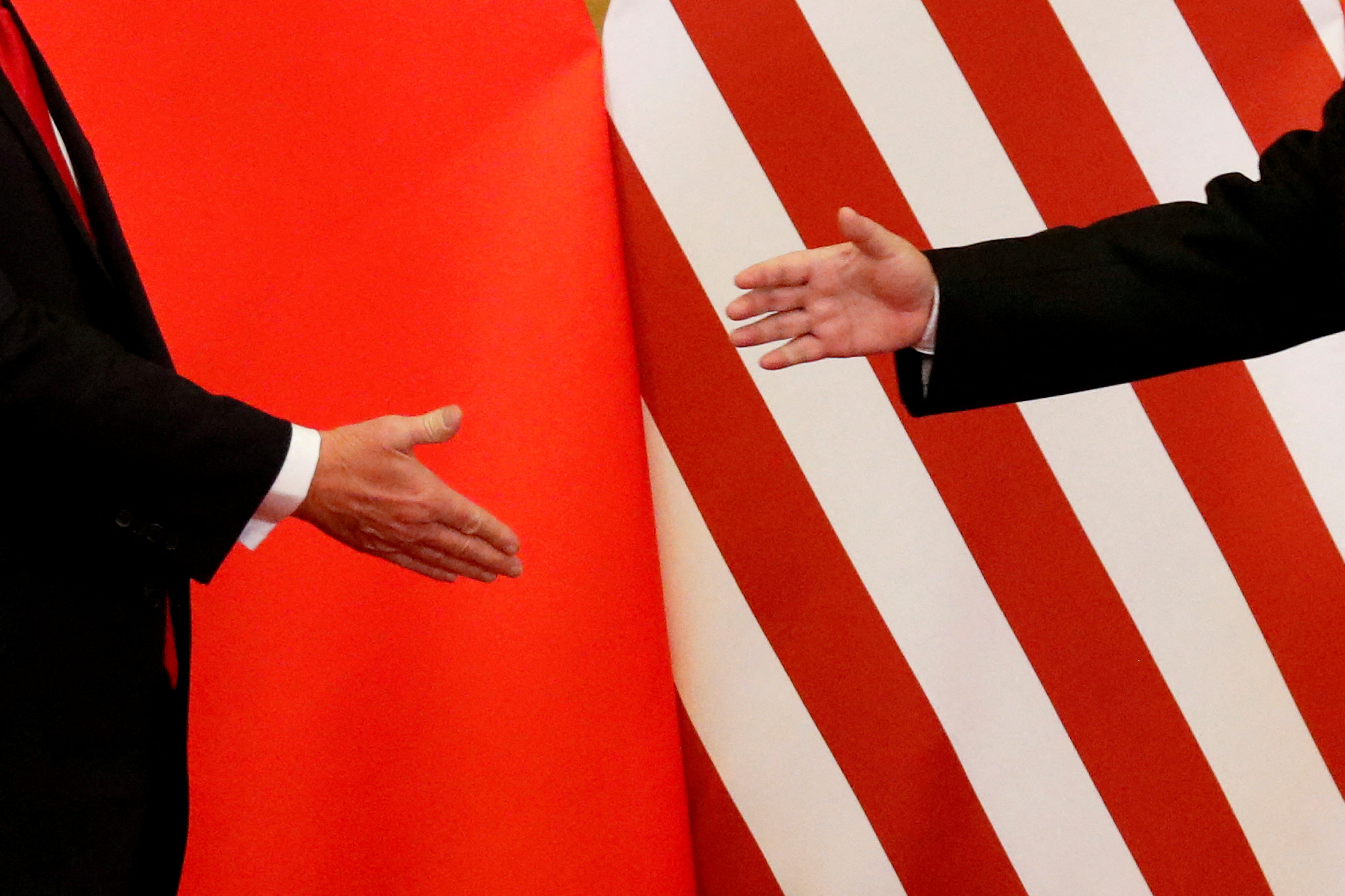 FILE PHOTO: U.S. President Donald Trump and China's President Xi Jinping shake hands
