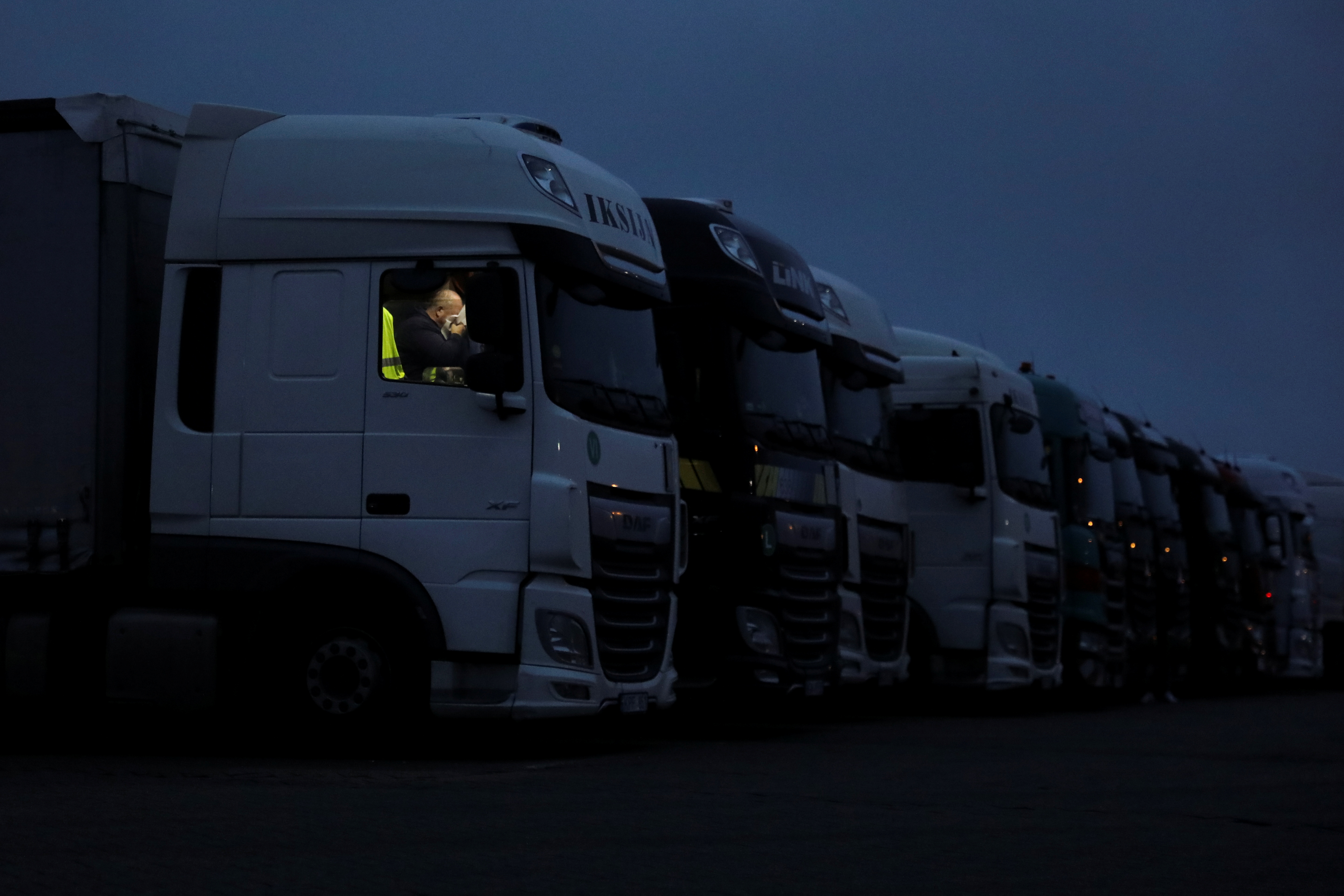 A driver rests inside his lorry at Ashford International Truck Stop, as EU countries impose a travel ban from the UK following the coronavirus disease (COVID-19) outbreak, in Ashford, Britain December 22, 2020. REUTERS/Simon Dawson