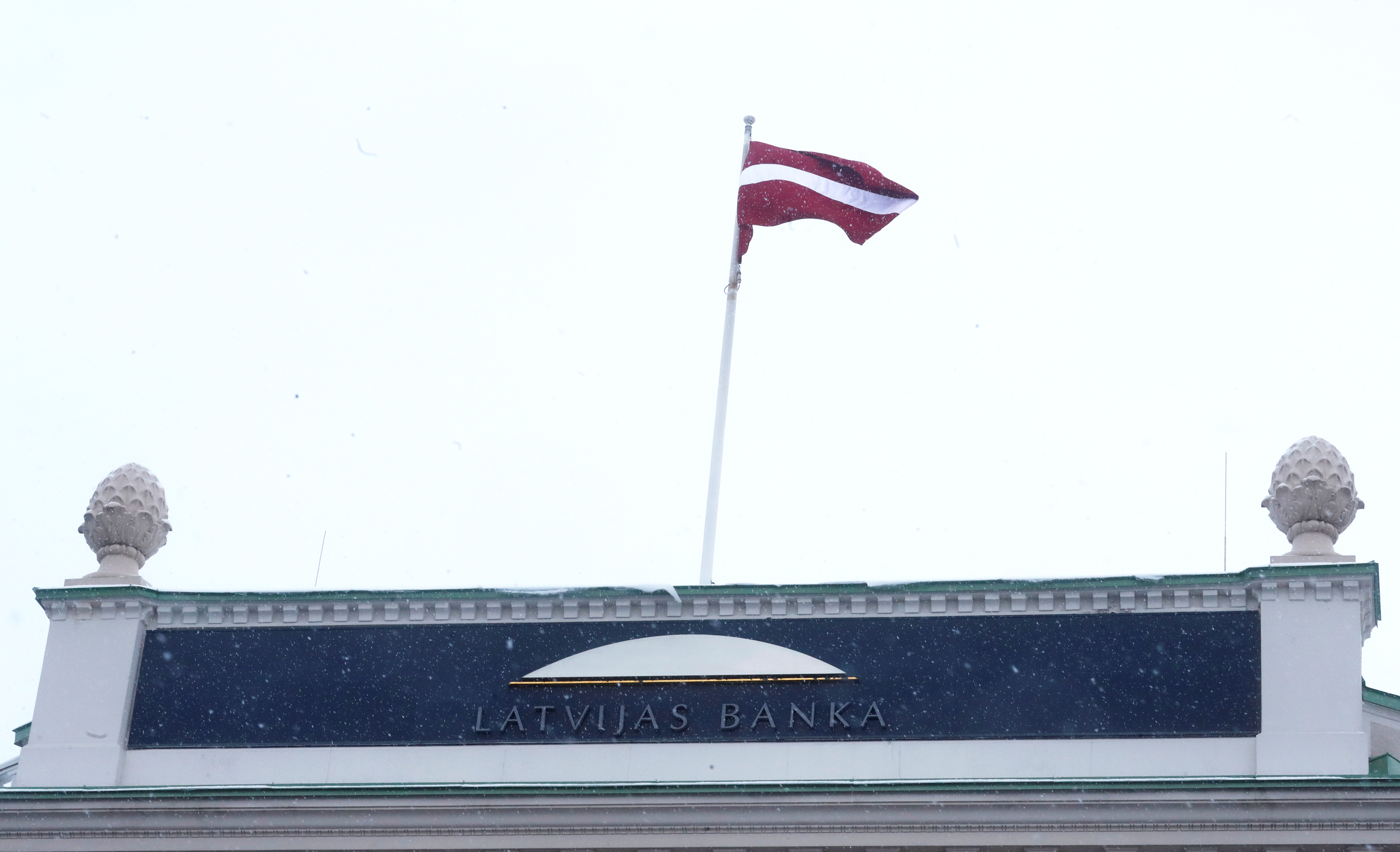 A national flag flutters over the Latvian central bank's headquarters in Riga
