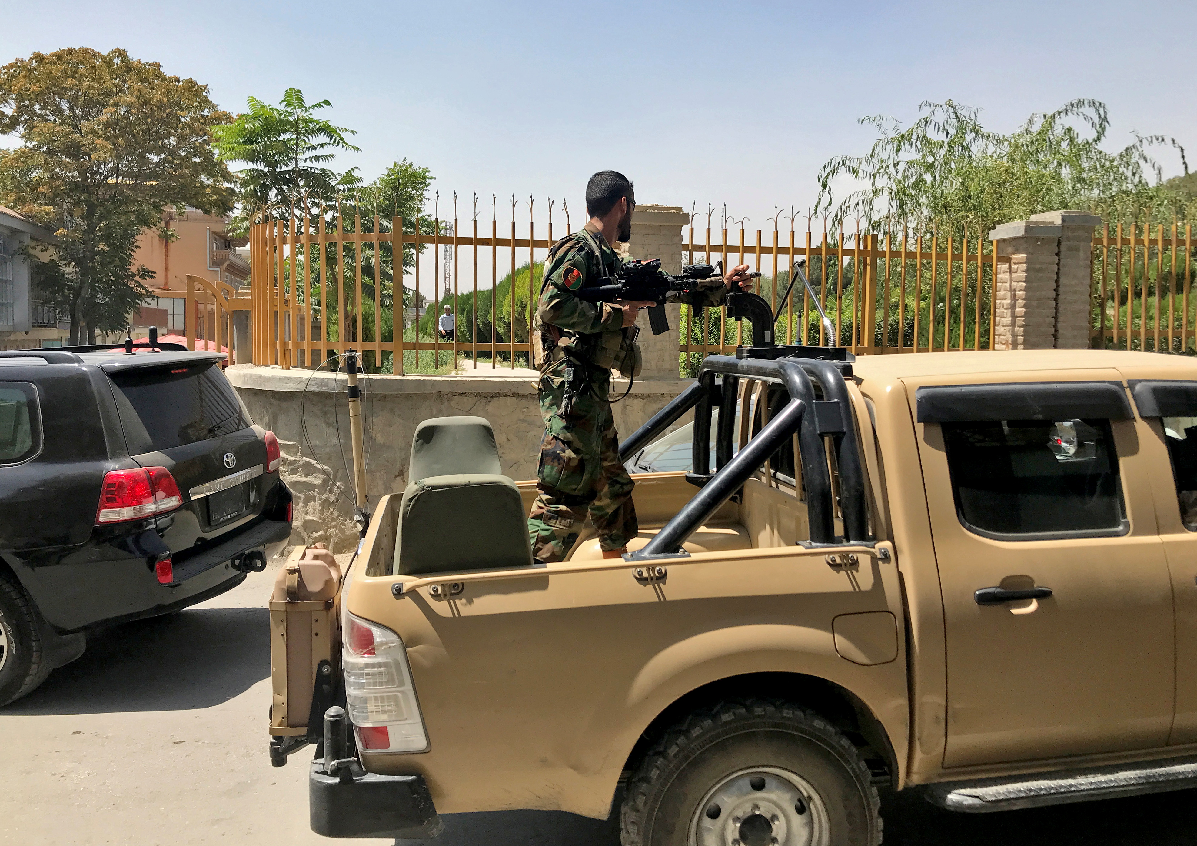 Afghan soldier stands in a military vehicle on a street in Kabul