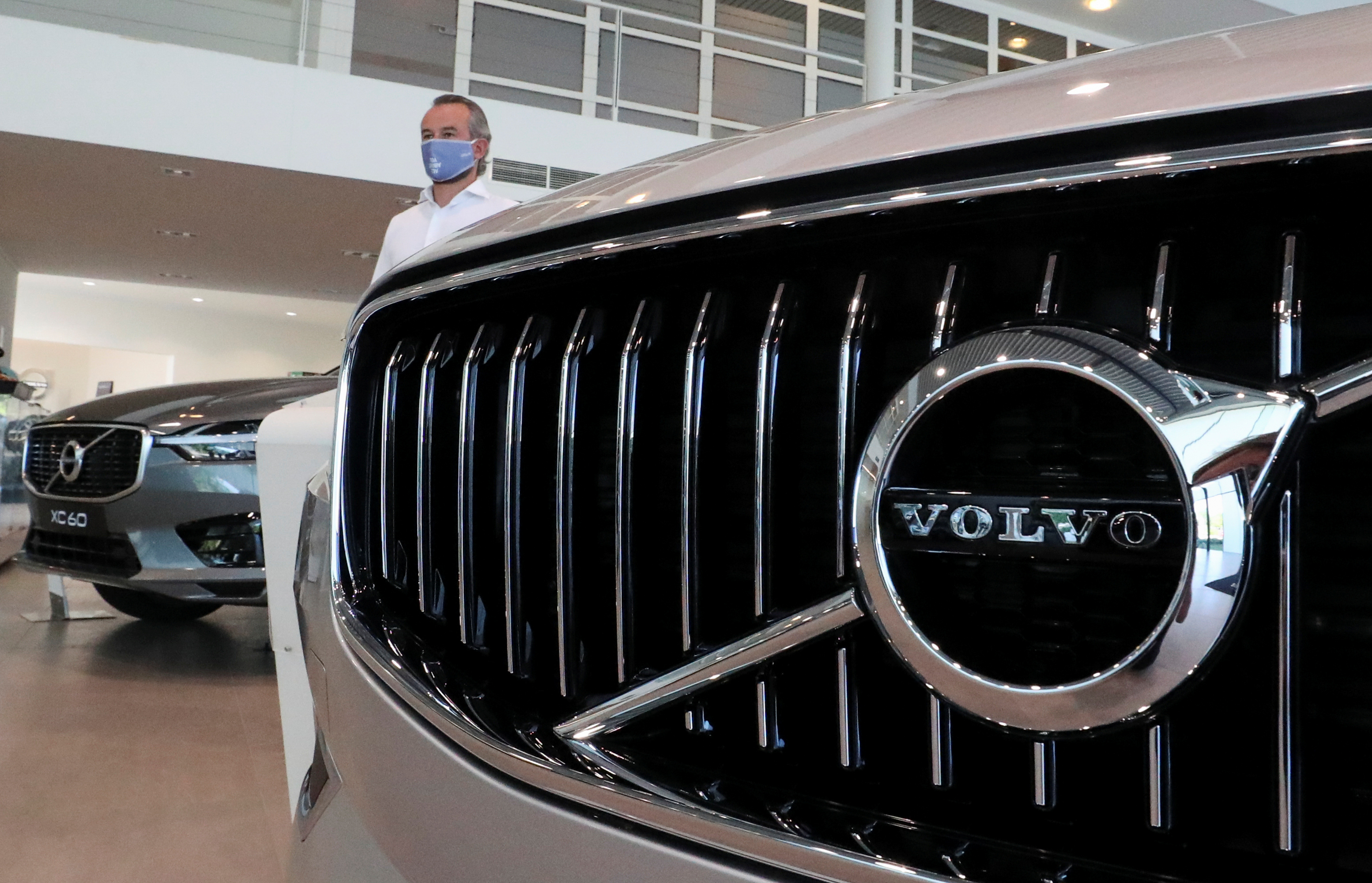 An employee at a Volvo car dealer, is seen in the showroom in Brussels