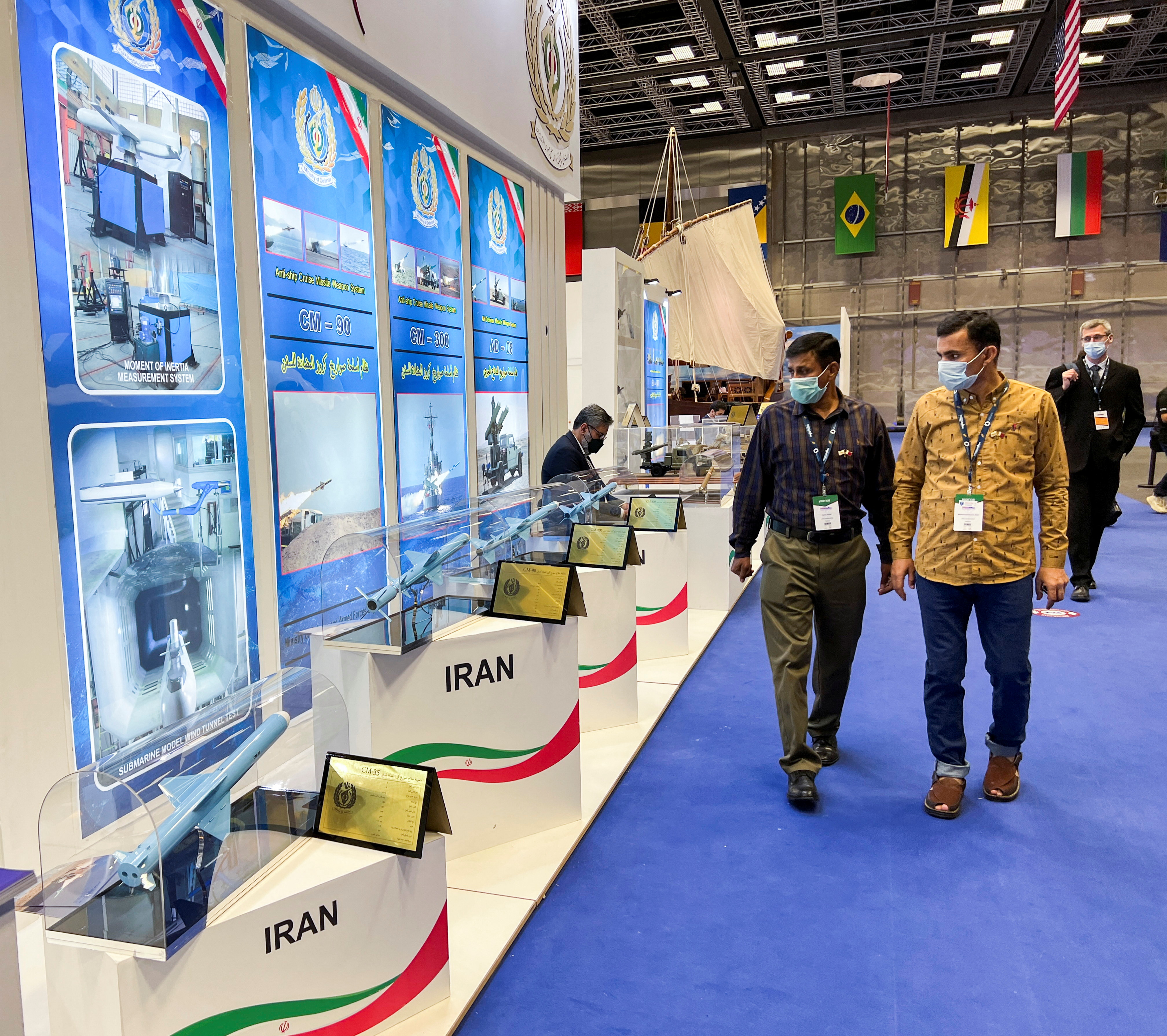 Visitors look at Anti-ship Cruise Missile Weapon System models at the IRGC booth at the Doha International Maritime Defense Exhibition and Conference (DIMDEX) in Doha