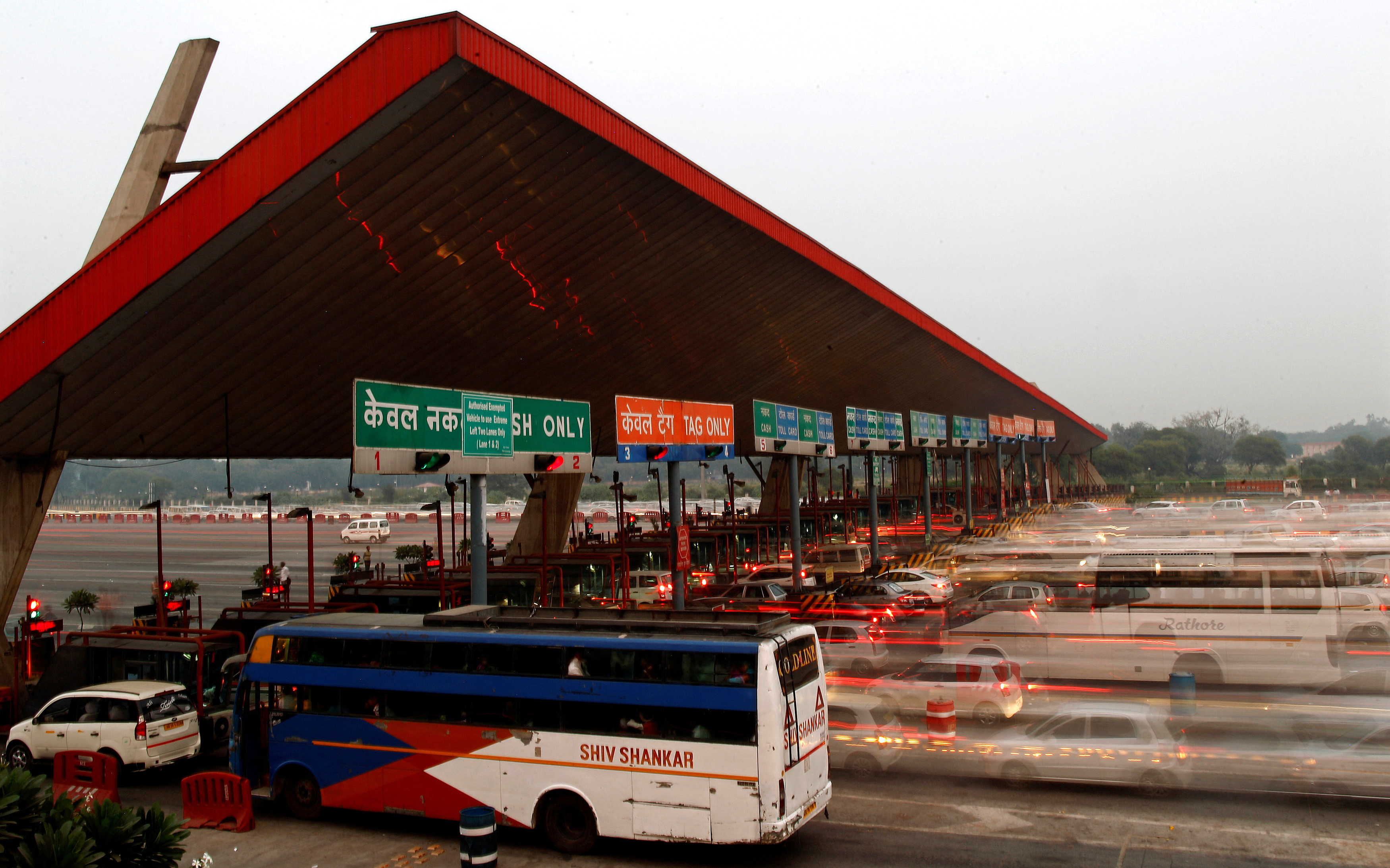 Vehicles pass through a toll plaza in Gurgaon on the outskirts of New Delhi, India