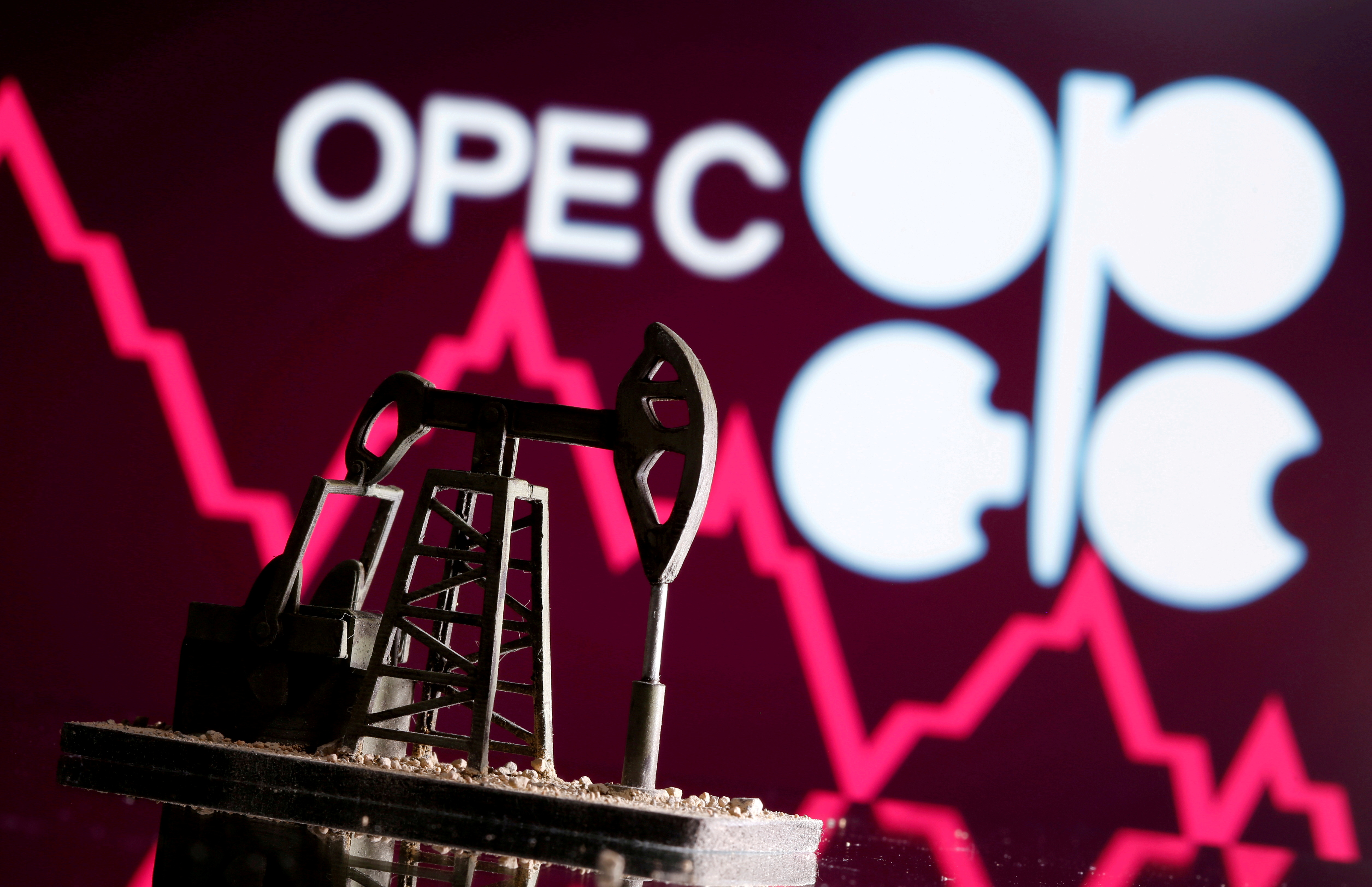 A 3D printed oil pump jack is seen in front of displayed stock graph and Opec logo in this illustration picture, April 14, 2020. REUTERS/Dado Ruvic/Illustration