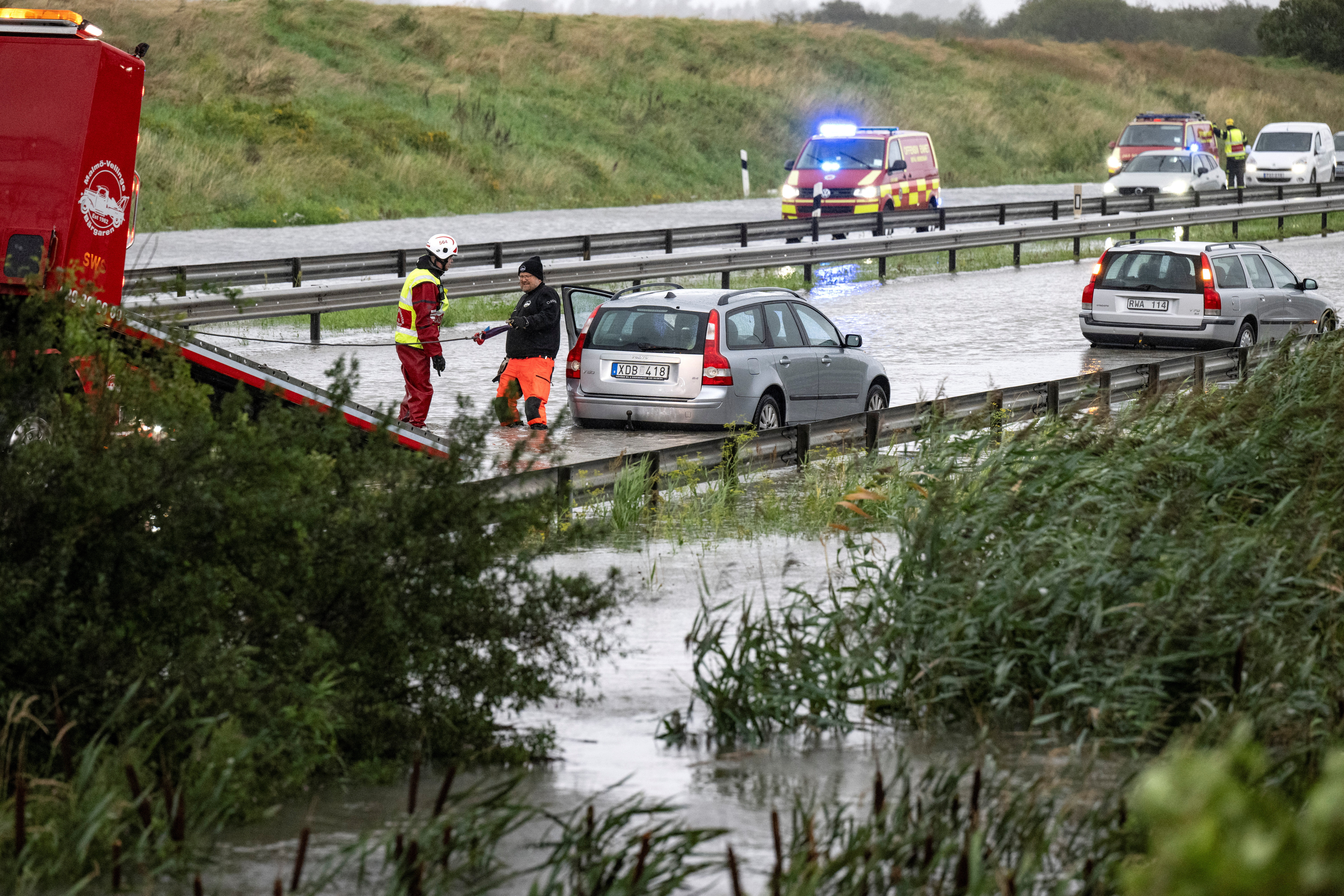 Crews tow stranded vehicles along a flooded E6 outside Malmo