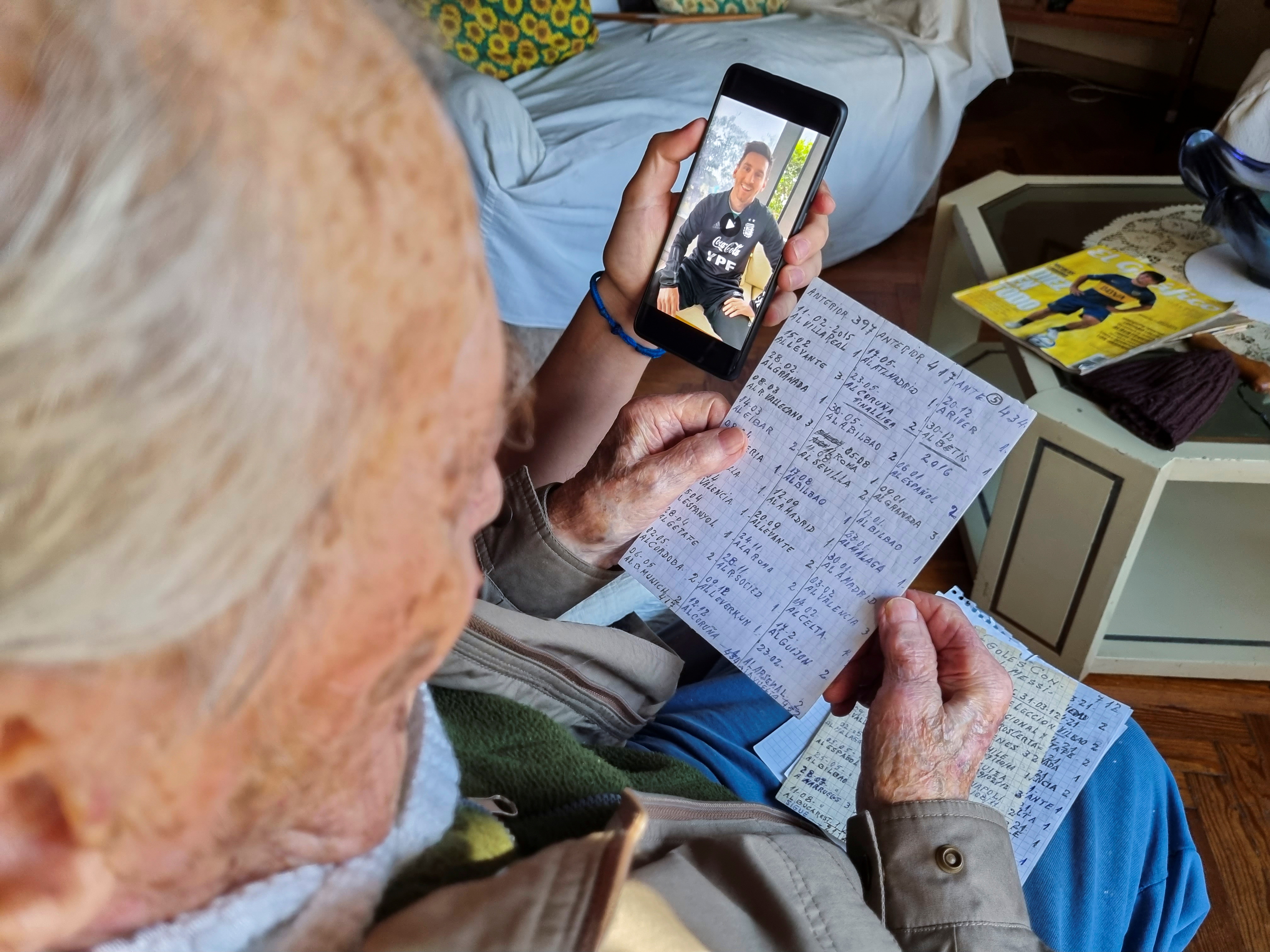 Hernan Mastrangelo, a 100-year-old fan of Lionel Messi, writes down all of Messi's goals in his notebook in Buenos Aires