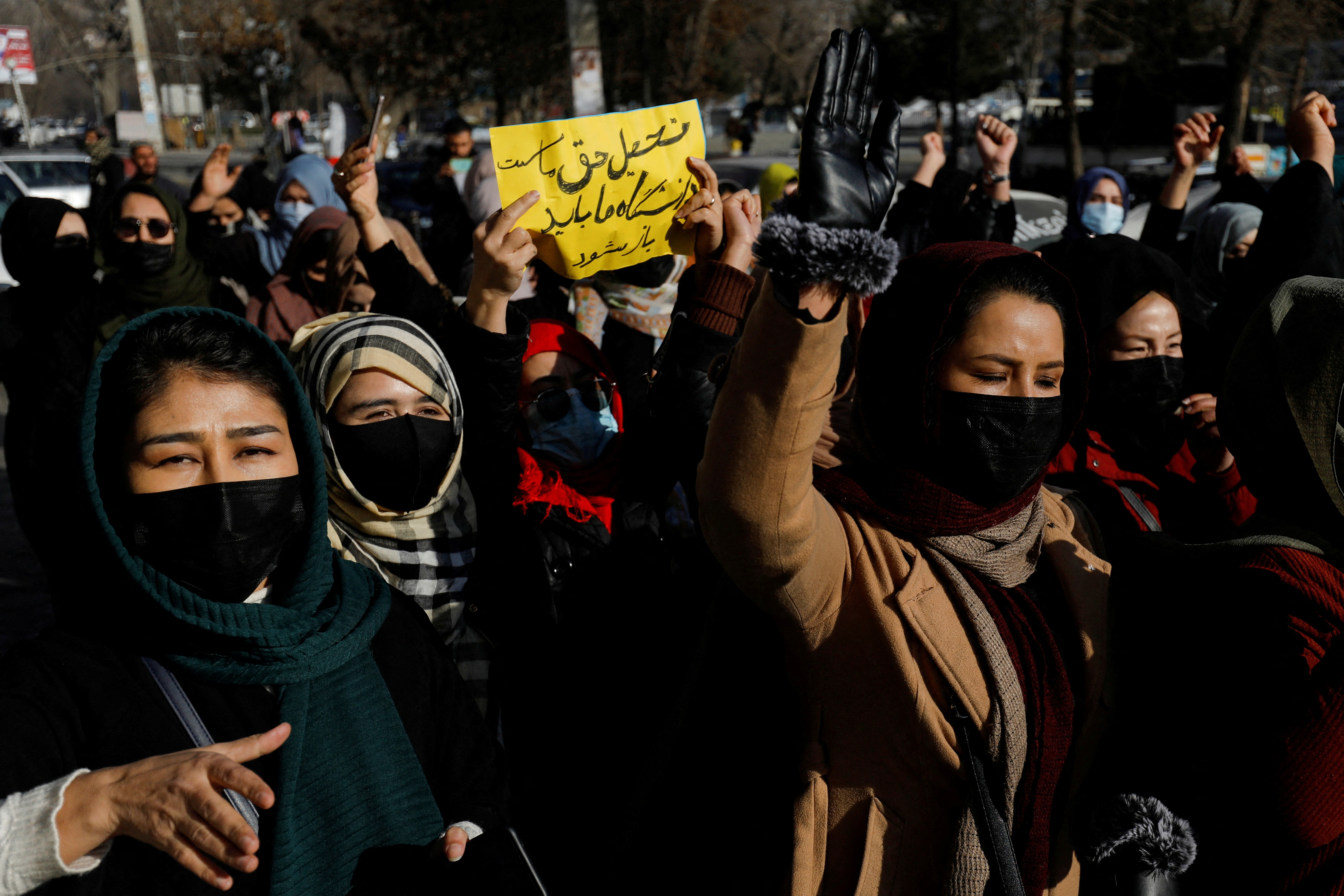 Afghan women chant slogans in protest against the closure of universities to women by the Taliban in Kabul