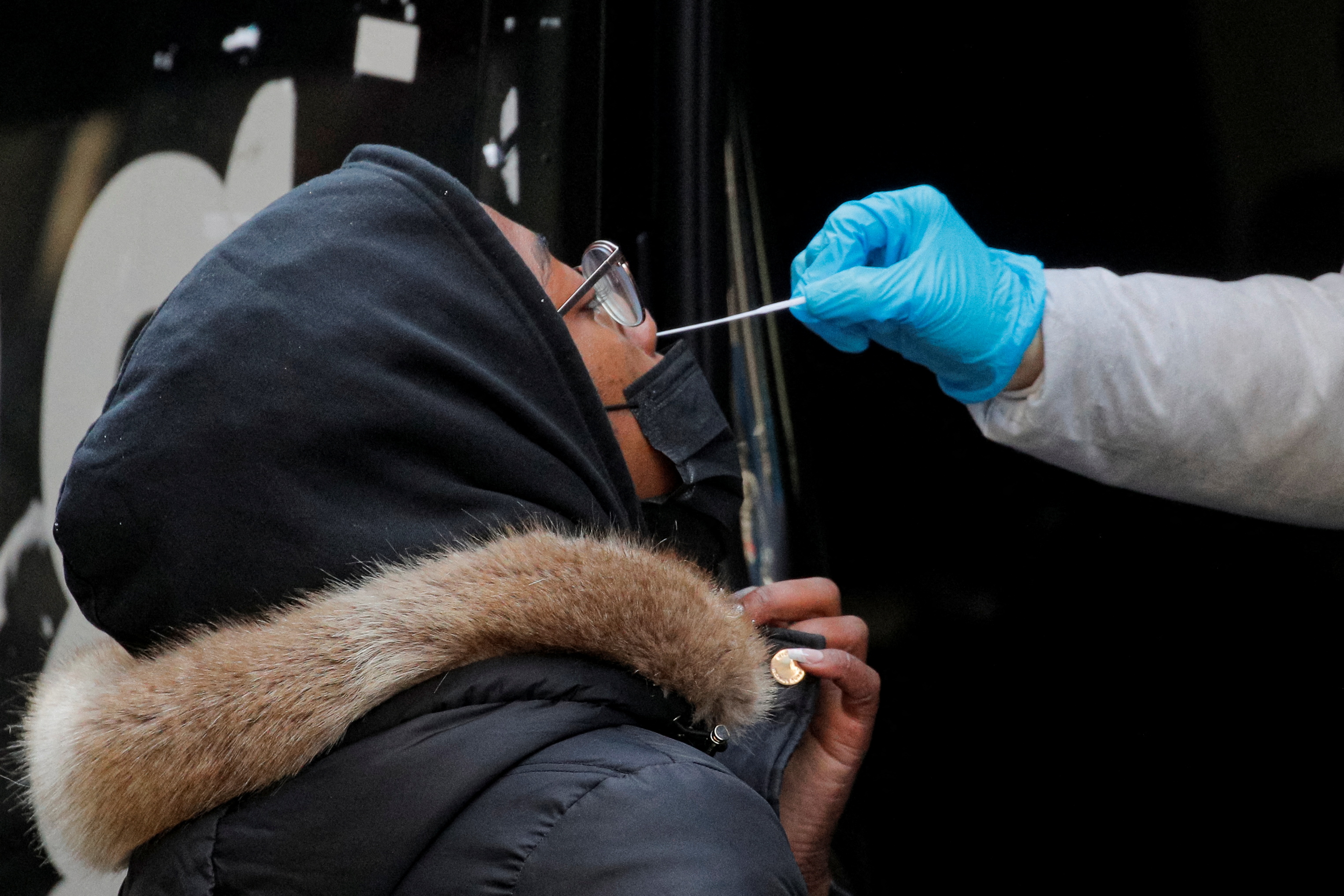 A woman takes a coronavirus disease (COVID-19) test at pop-up testing site in Brooklyn, New York, U.S., January 7, 2022. REUTERS/Brendan McDermid
