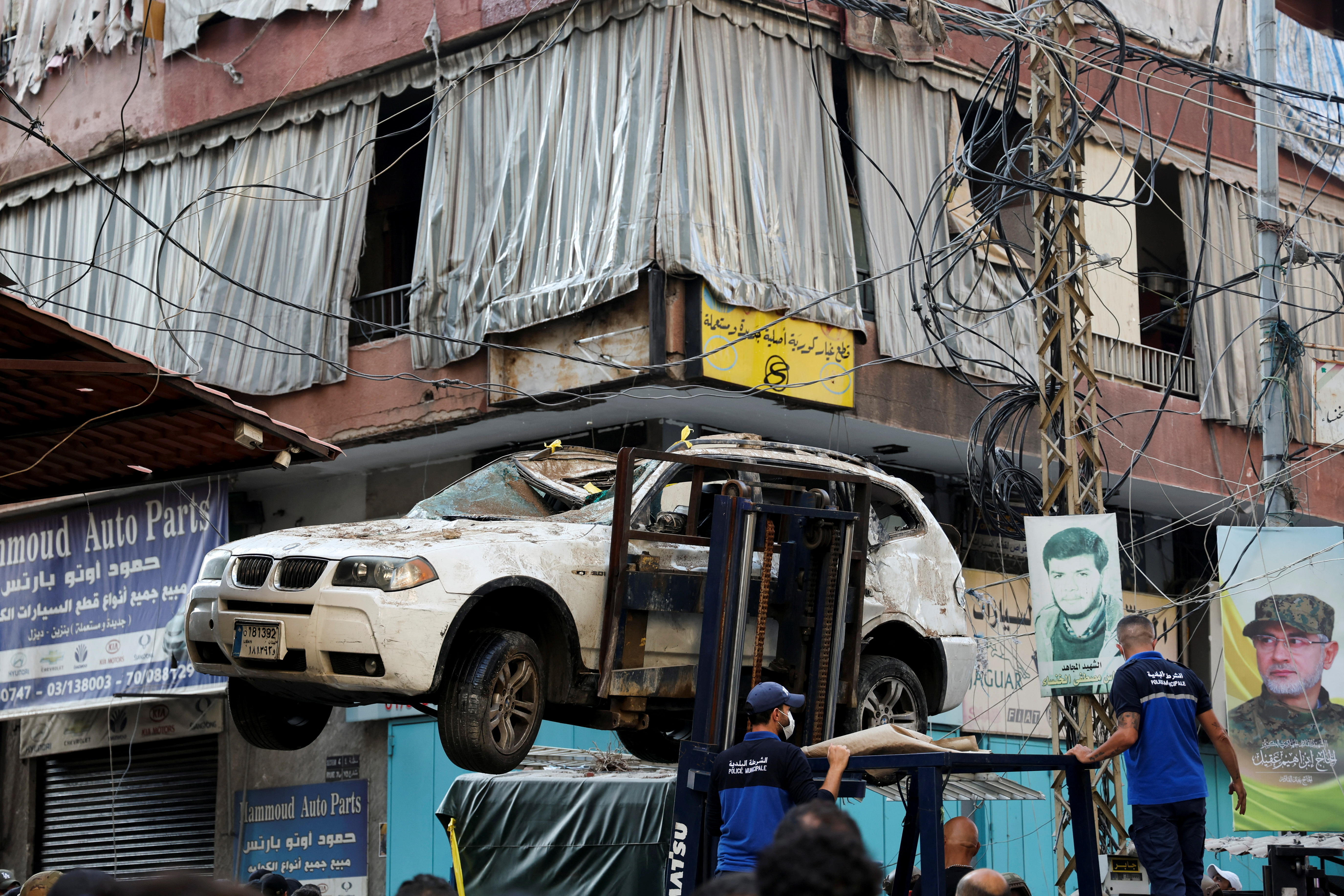 People gather at the site of an Israeli strike in Beirut's southern suburbs