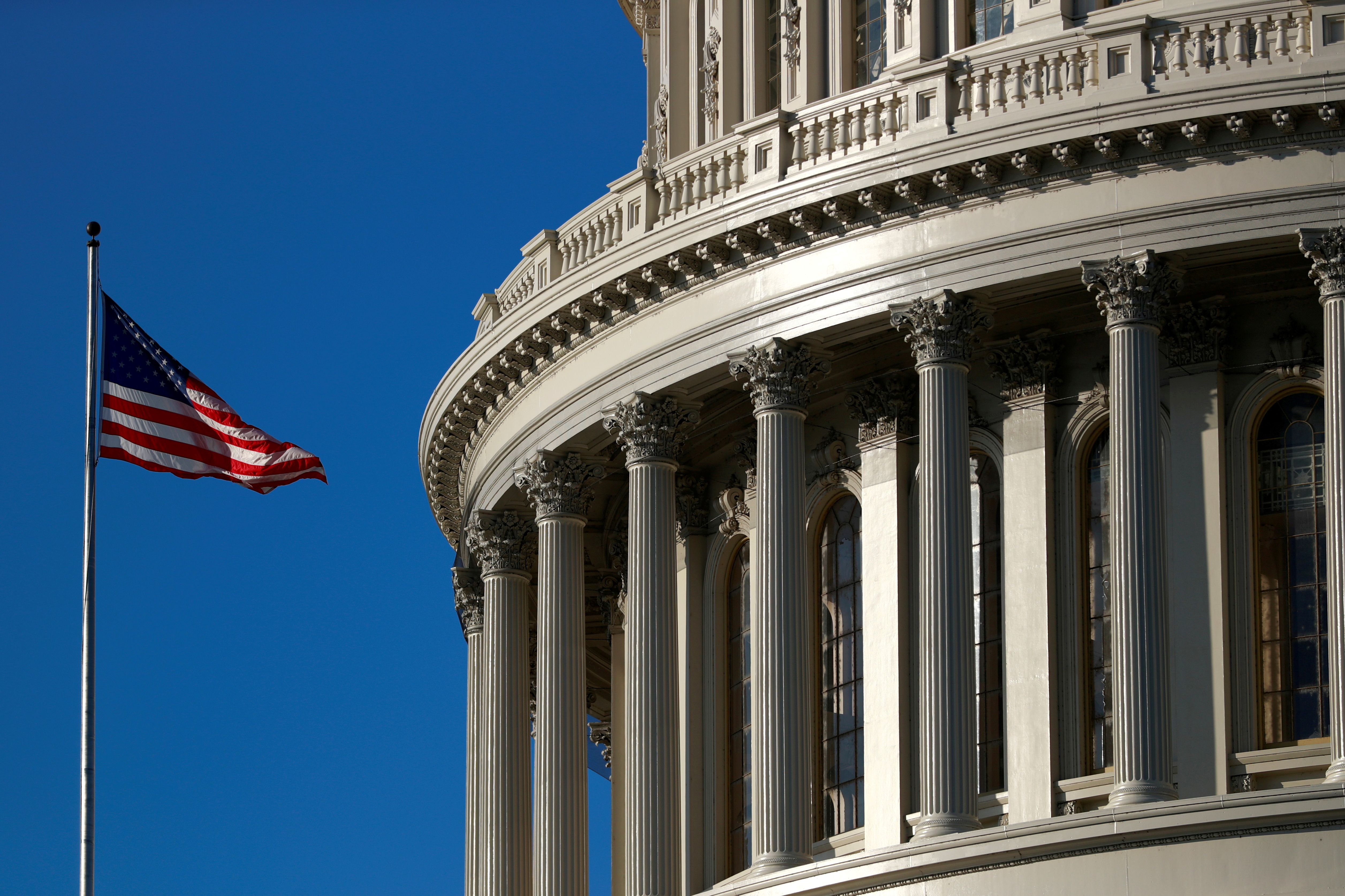 A U.S. flag flies outside of the Capitol dome in Washington