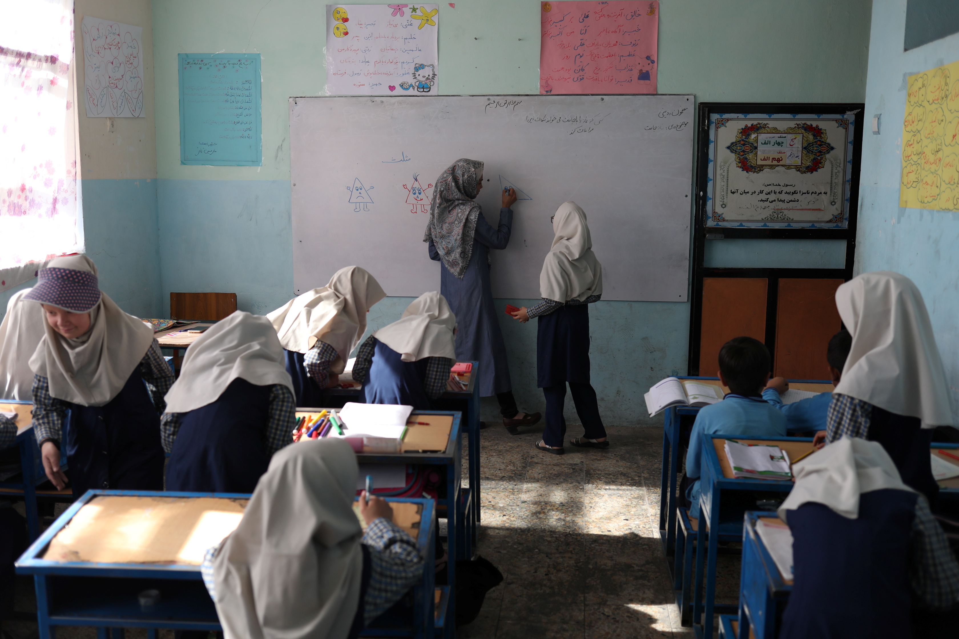Afghan girls attend a class at a school in Kabul
