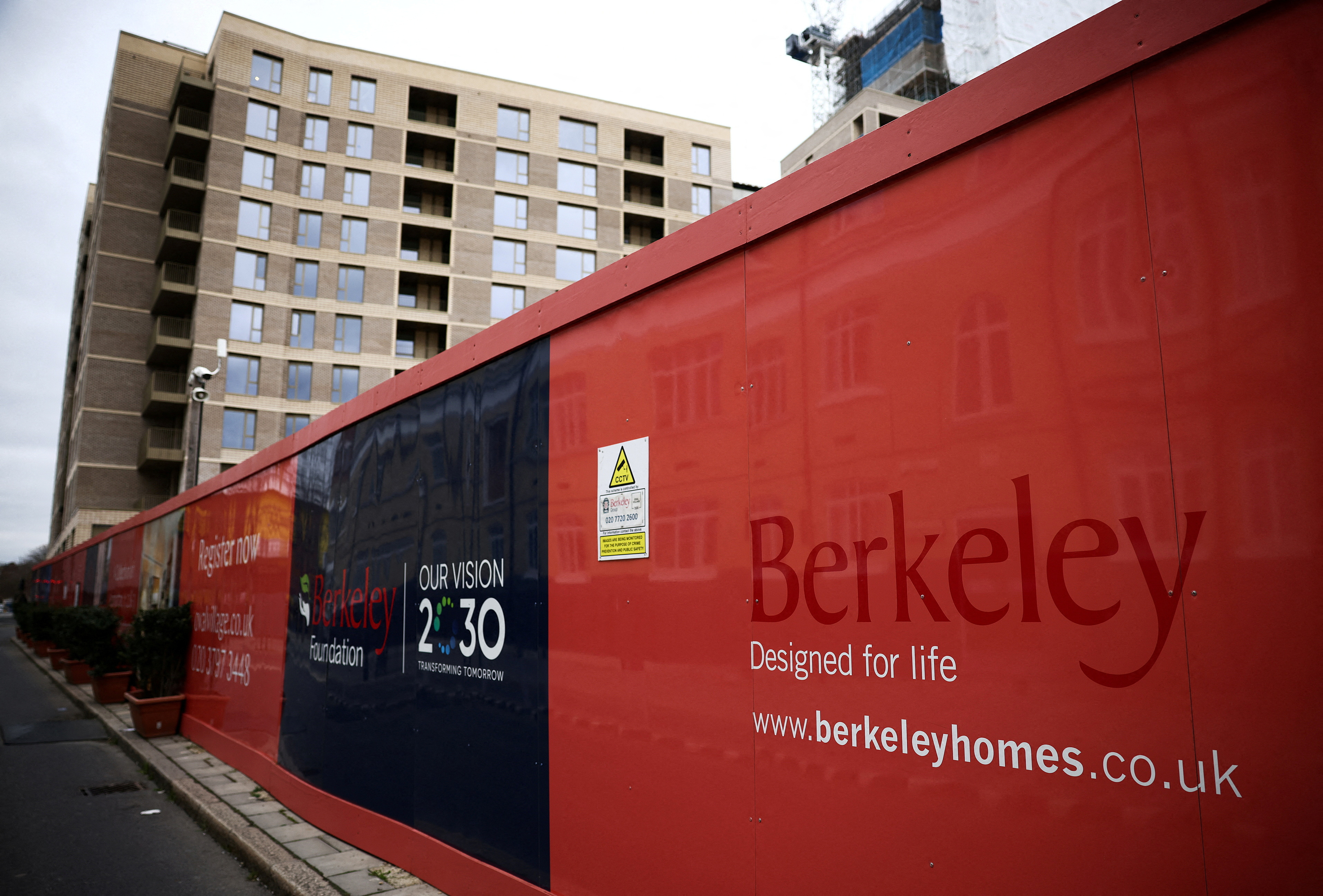 Hoardings display a logo of Berkeley Group outside a development in London