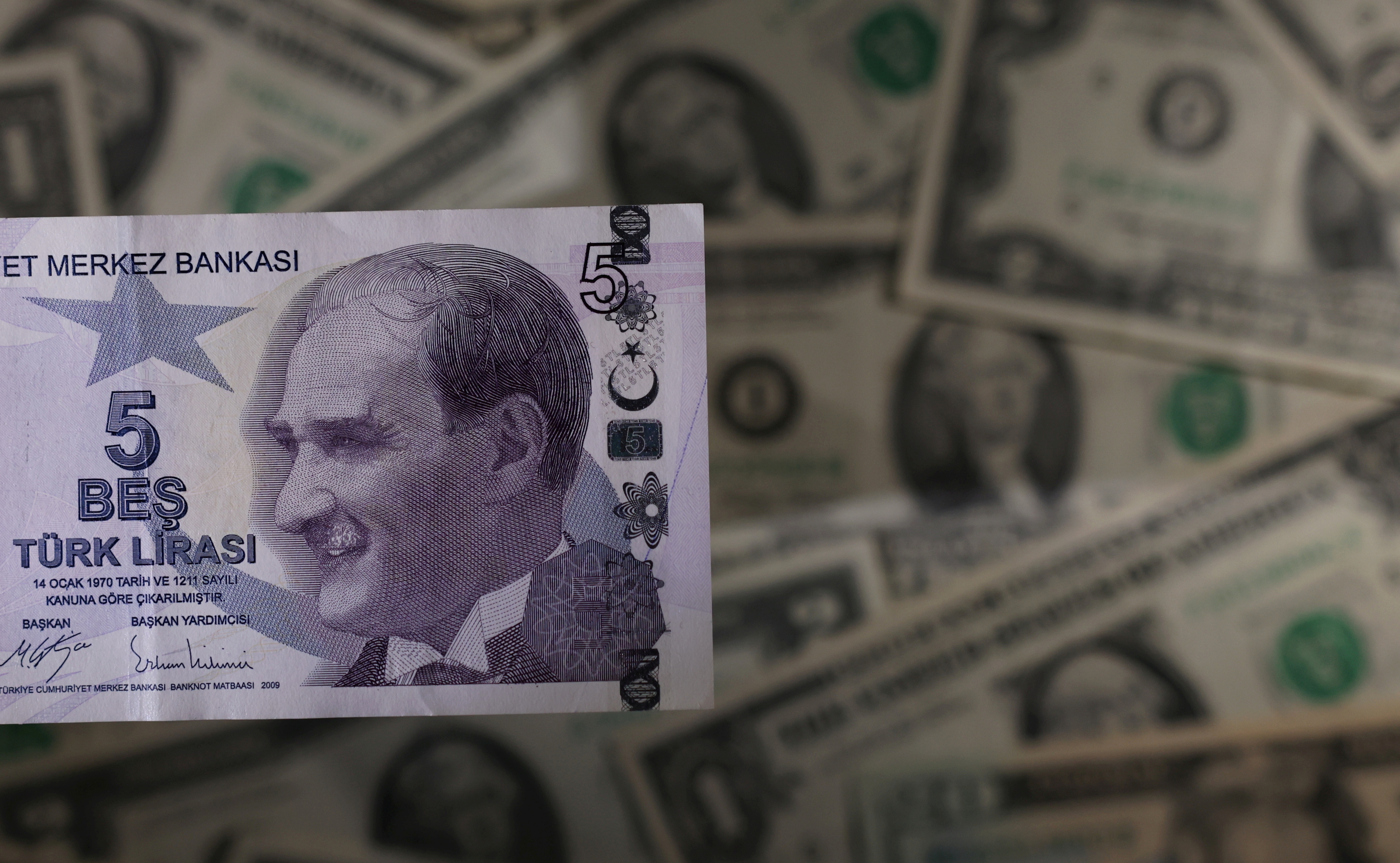 Turkish lira banknote is seen placed on U.S. Dollar banknotes in this illustration taken, November 28, 2021. REUTERS/Dado Ruvic/Illustration