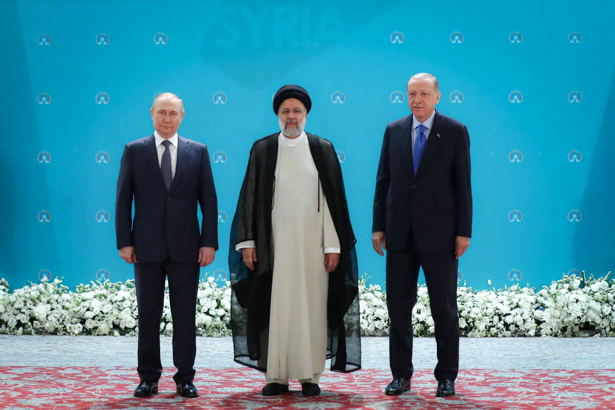Russian President Vladimir Putin, Iranian President Ebrahim Raisi and Turkish President Tayyip Erdogan pose for a photo before a meeting of leaders from the three guarantor states of the Astana process, designed to find a peace settlement in Syria crisis