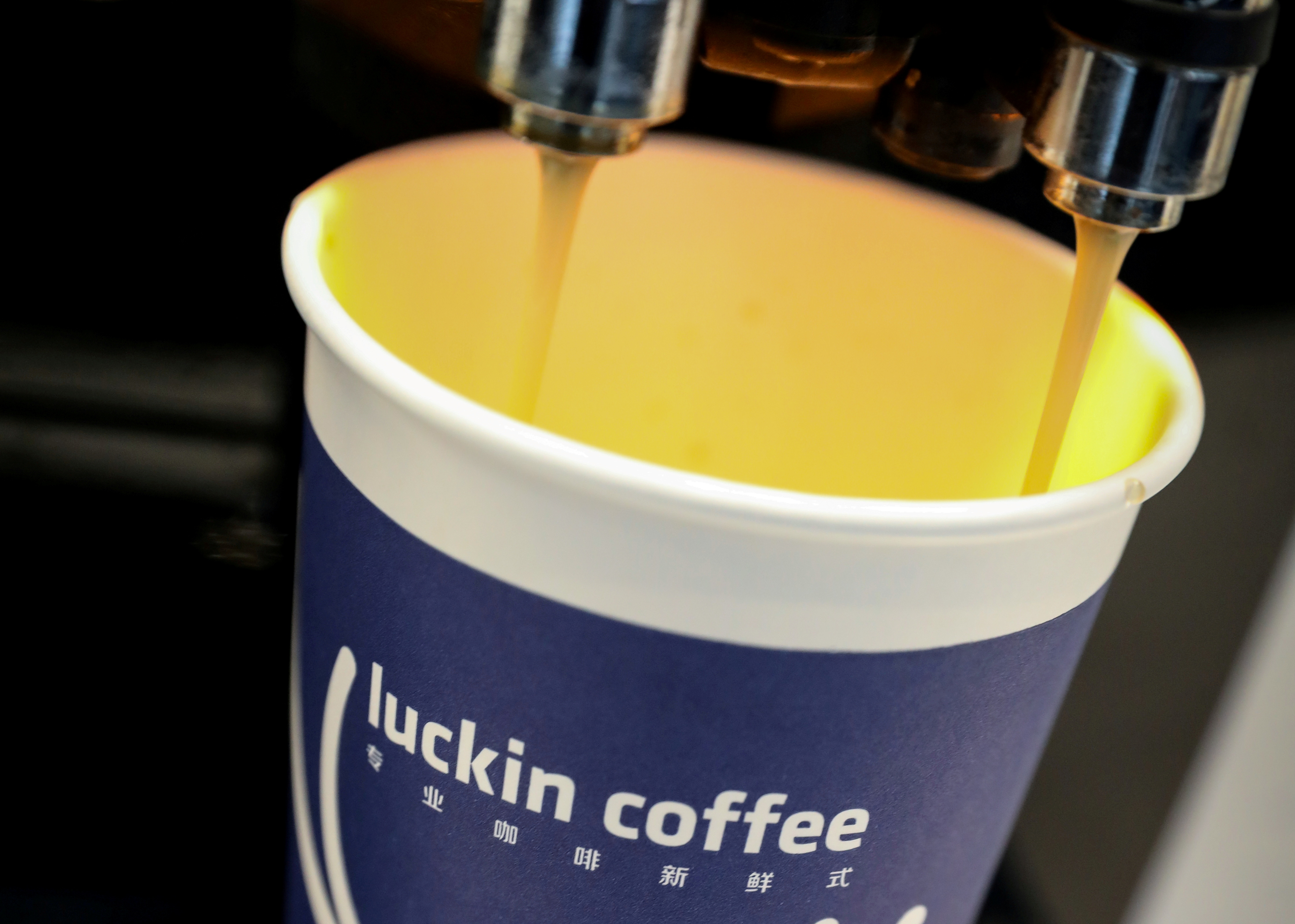 A cup of 'Luckin Coffee' coffee is poured during the company's IPO at the Nasdaq Market site in New York
