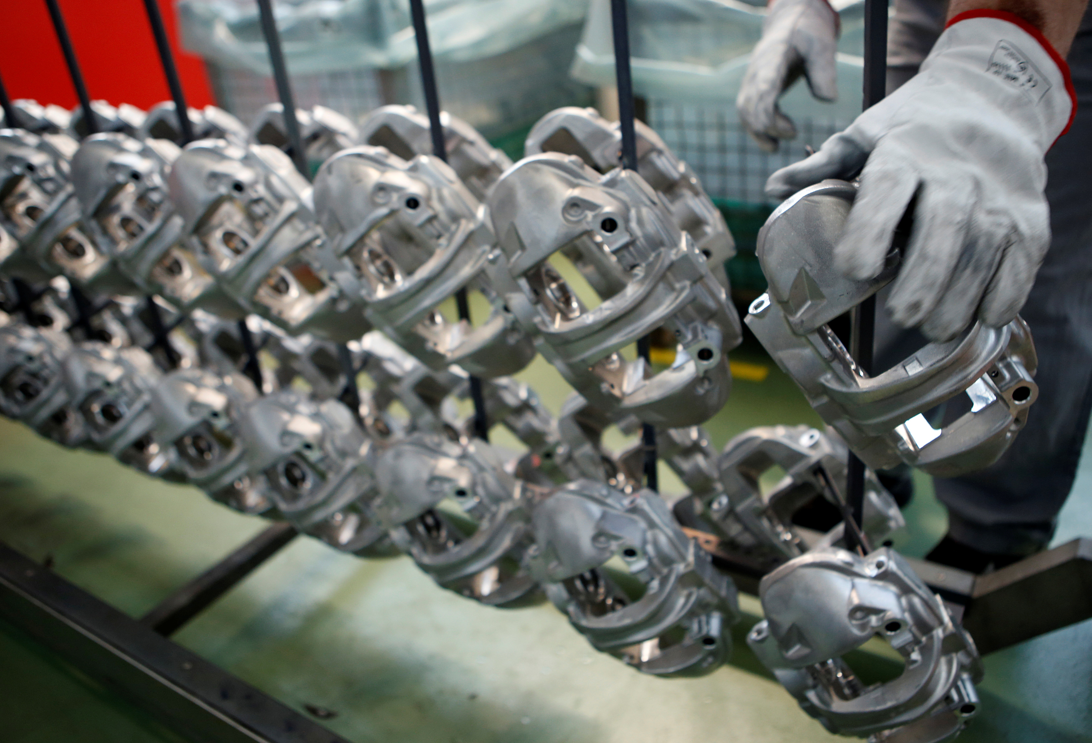 A technician works on brake disc components in the Brembo factory in Curno