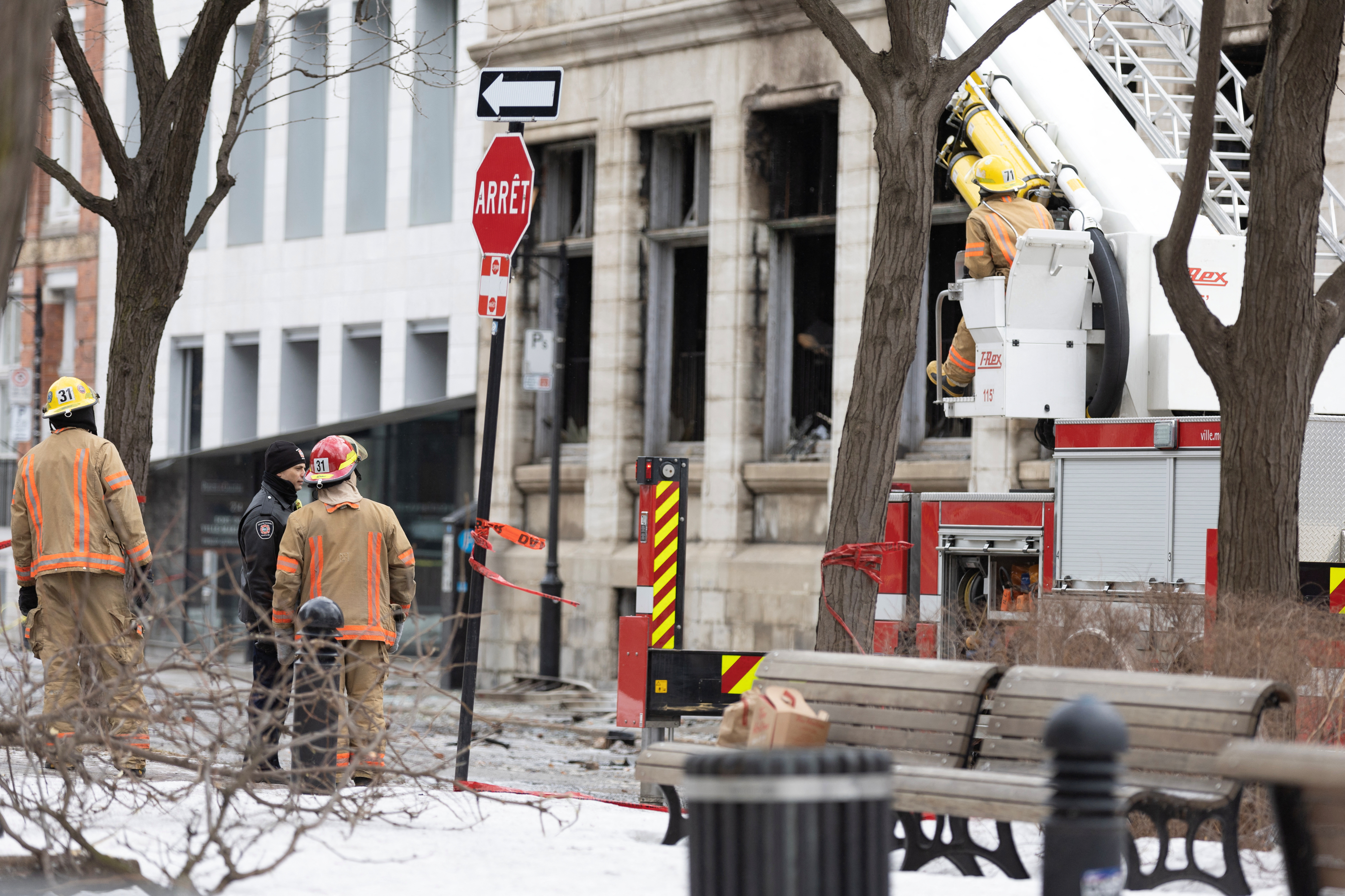 Canadian investigators inspect a heritage building before the search for seven unaccounted people after a fire in Montreal