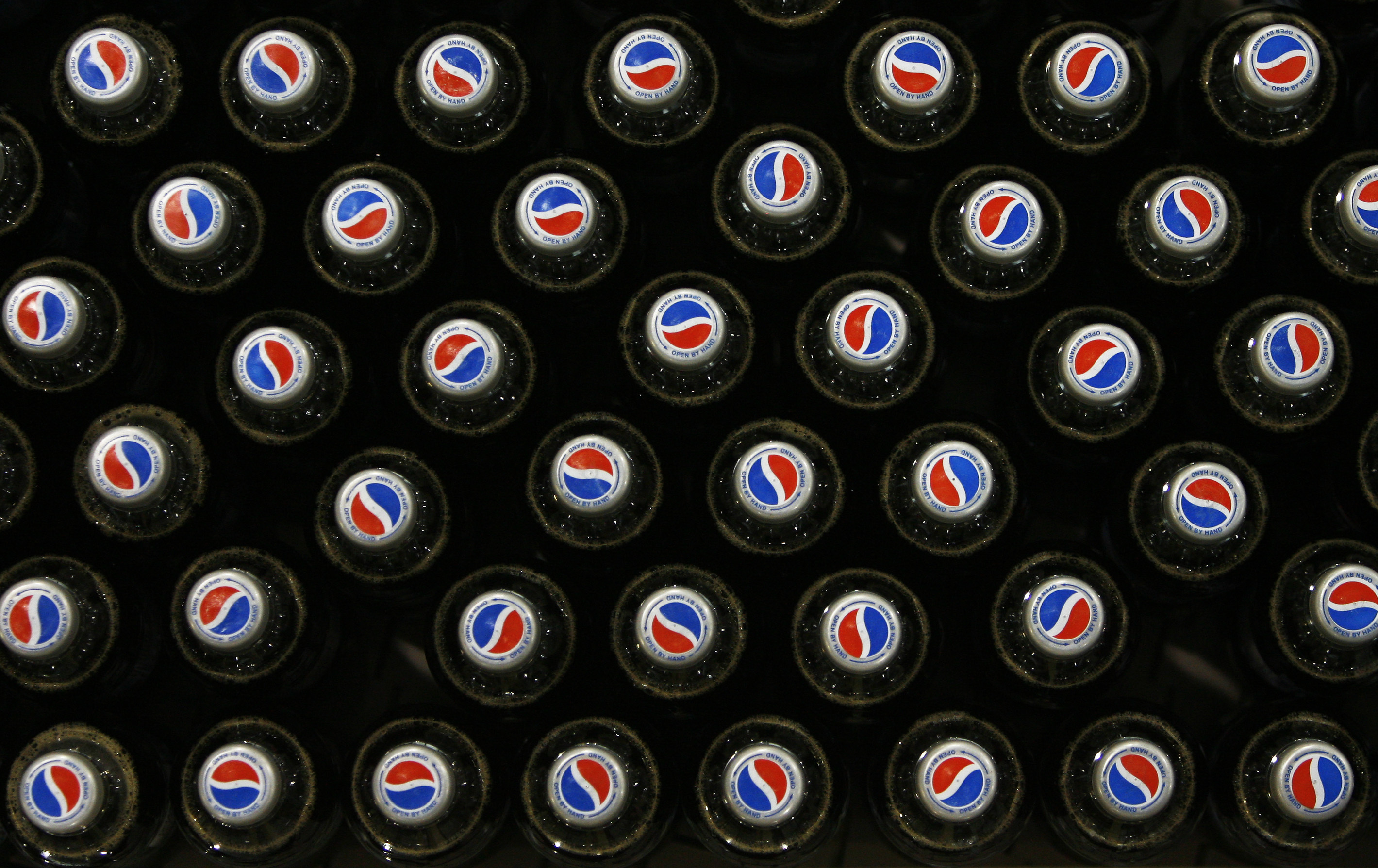 Pepsi bottles sit on a conveyor belt at drinks company Britvic's bottling plant in London