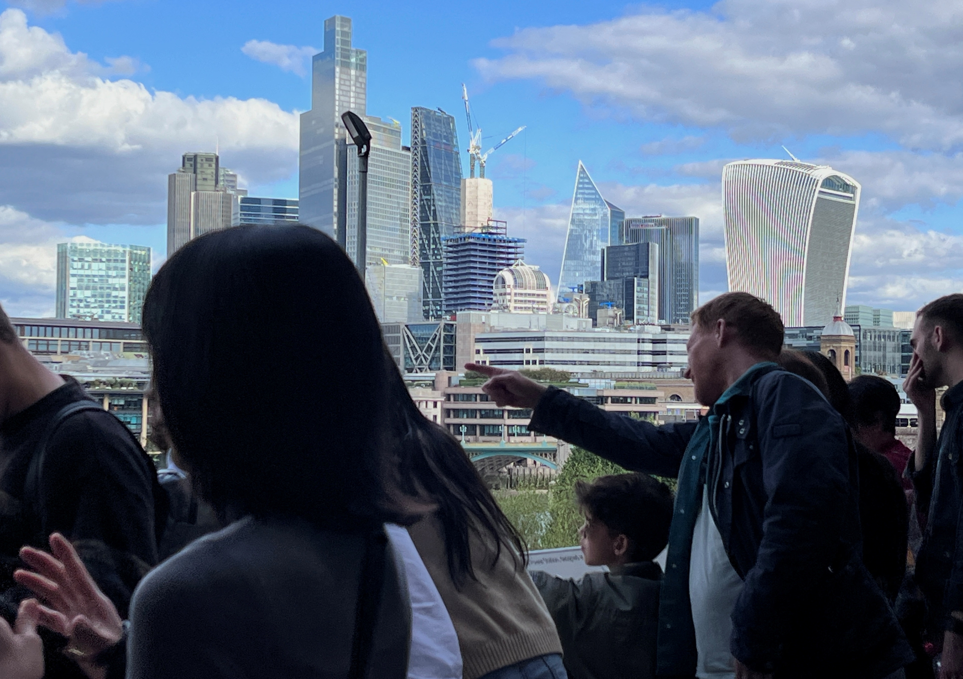 People look at a a view of the City of London skyline in