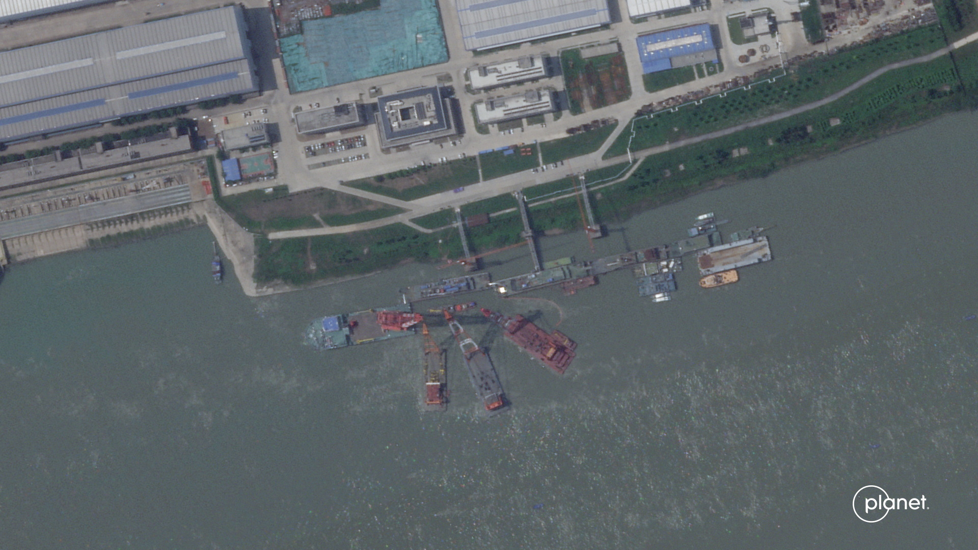 A series of satellite images from Planet Labs from June appear to show cranes at the Wuchang shipyard