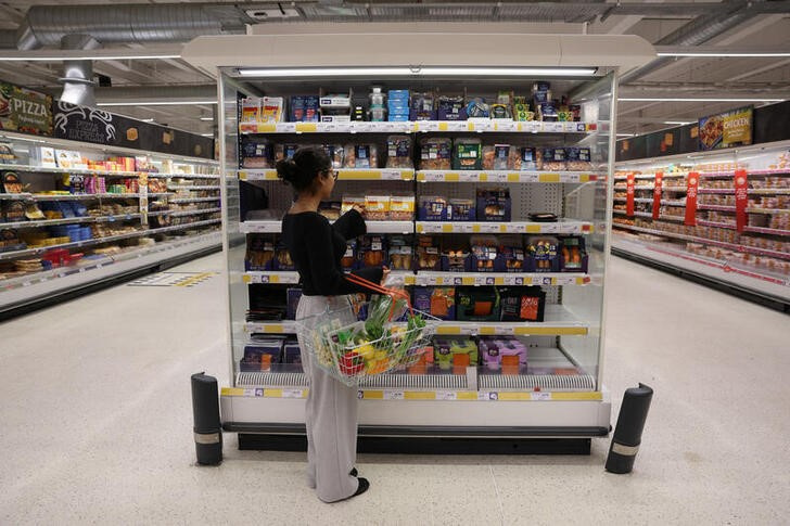 A customer shops in the fish aisle inside a Sainsbury’s supermarket in London