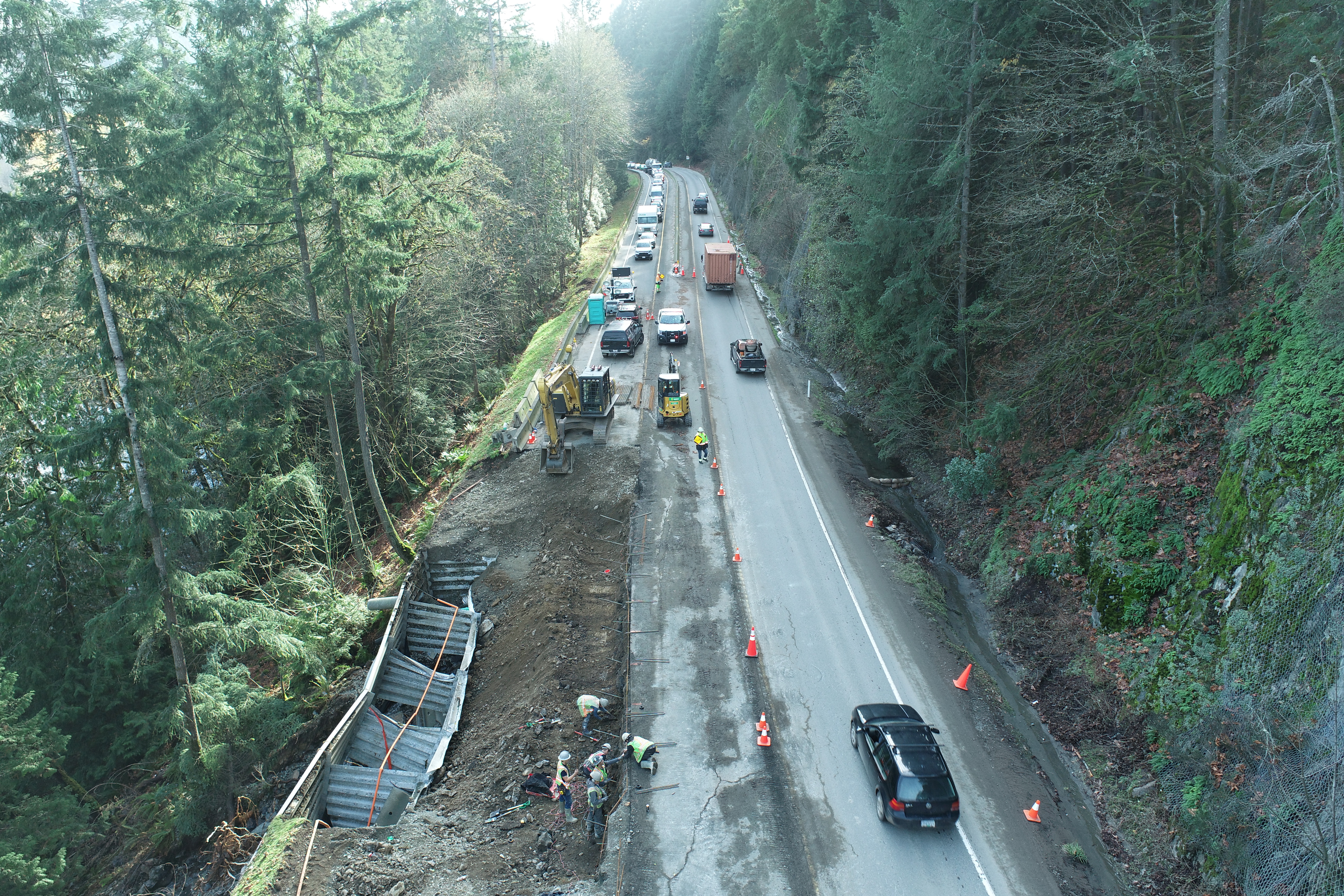 Workers inspect a washed out lane of Trans Canada Highway 1 after devastating rain storms caused flooding and landslides, in Malahat, British Columbia, Canada November 17, 2021. Picture taken November 17, 2021. B.C. Ministry of Transportation and Infrastructure/Handout via REUTERS.  NO RESALES. NO ARCHIVES. THIS IMAGE HAS BEEN SUPPLIED BY A THIRD PARTY.