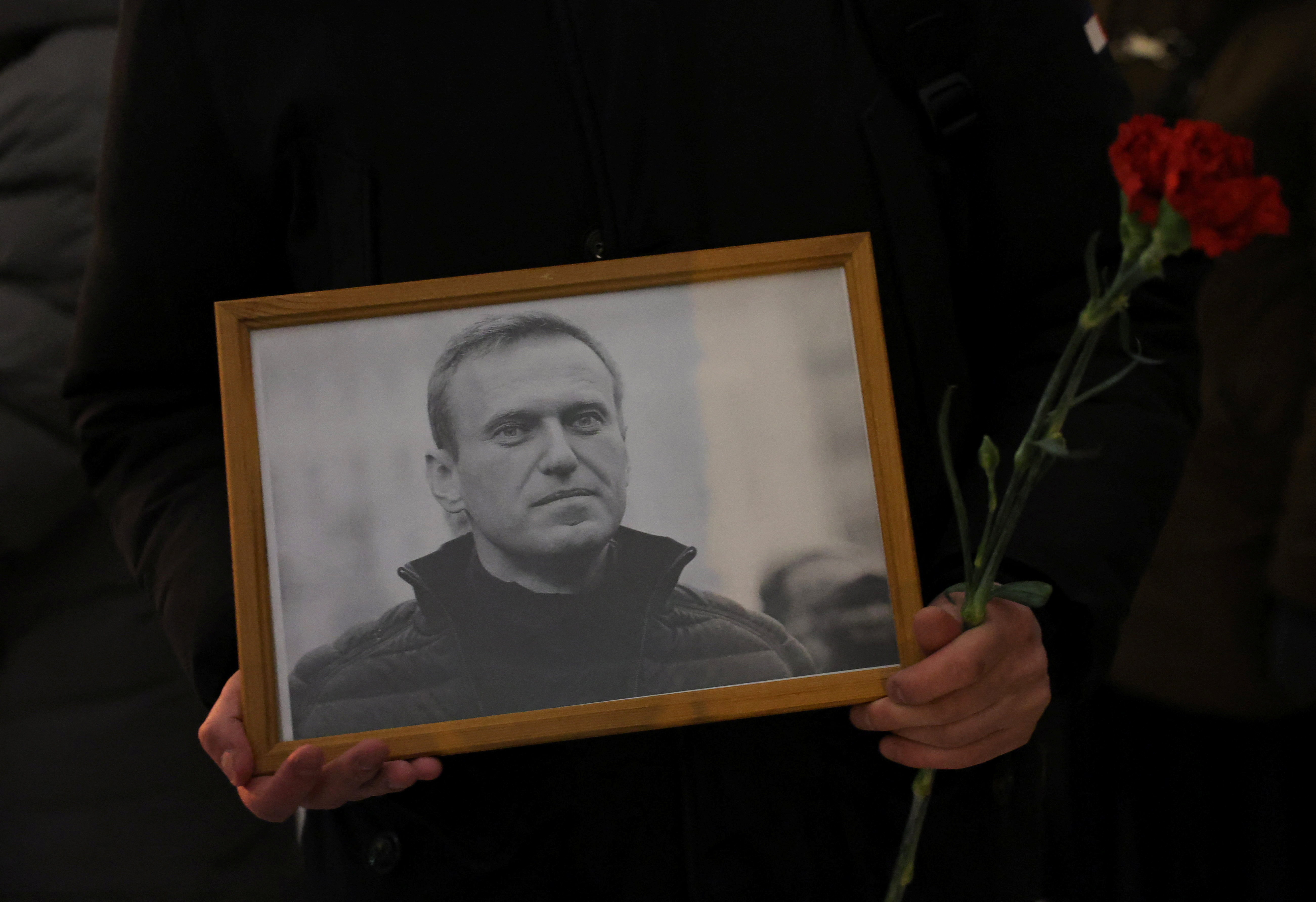 People gather at the monument to the victims of political repressions following the death of Alexei Navalny in Saint Petersburg