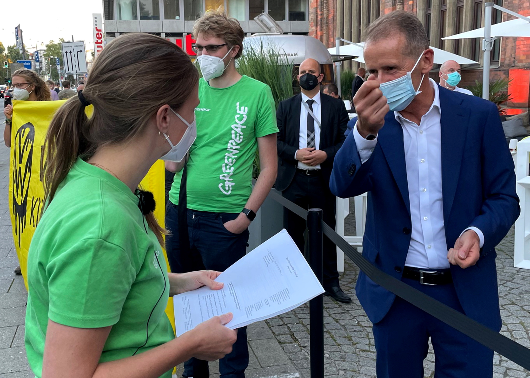 Herbert Diess, CEO of German carmaker Volkswagen AG talks to members of Greenpeace ahead of the Munich Motor Show IAA Mobility 2021, in Munich, Germany, September 5, 2021. REUTERS/Jan Schwartz