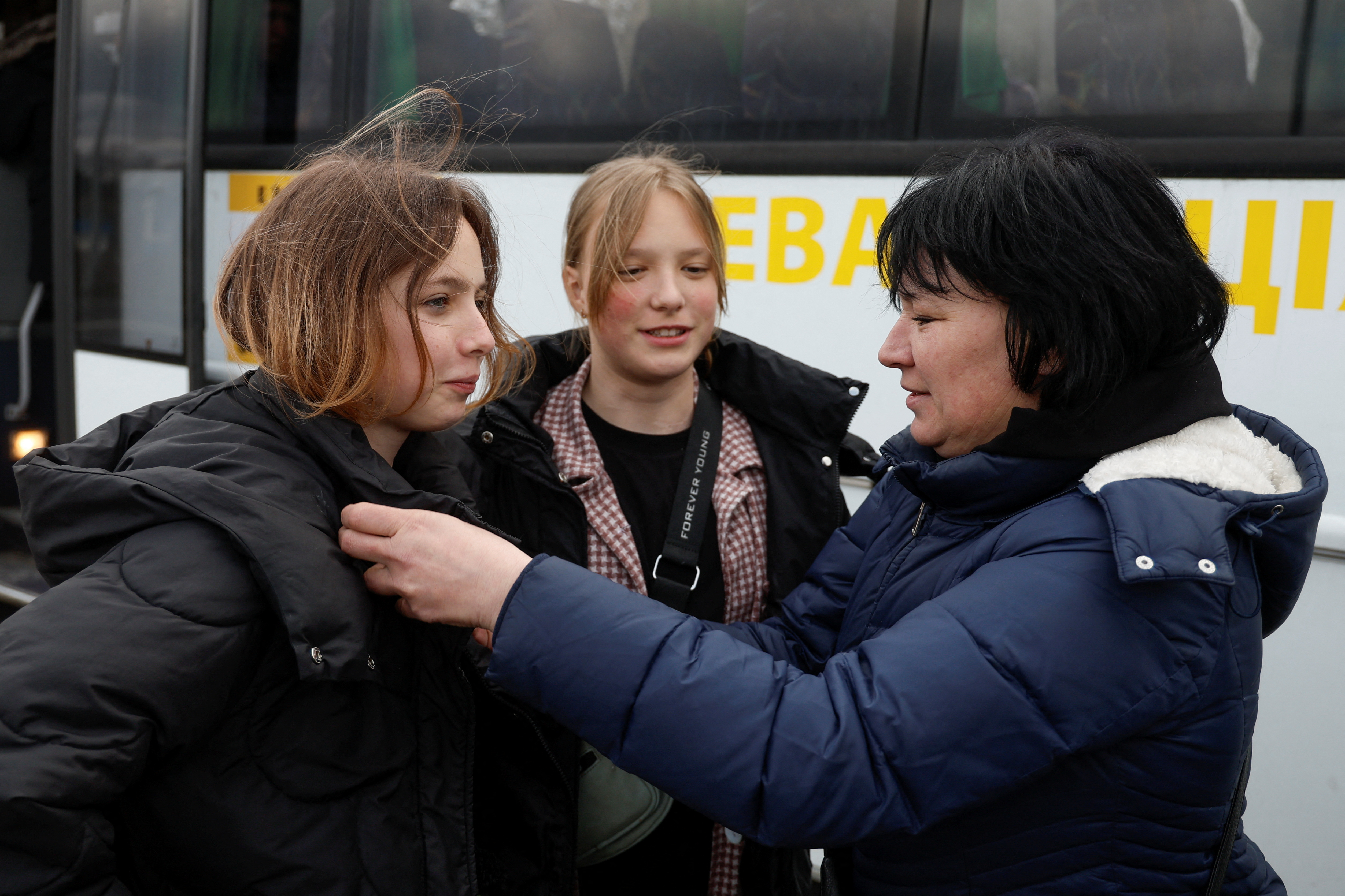 Natalia Rakk speaks with her 14-year-old daughters Dasha and Aliona, taken to Russia, after returning via the Ukraine-Belarus border in Volyn region