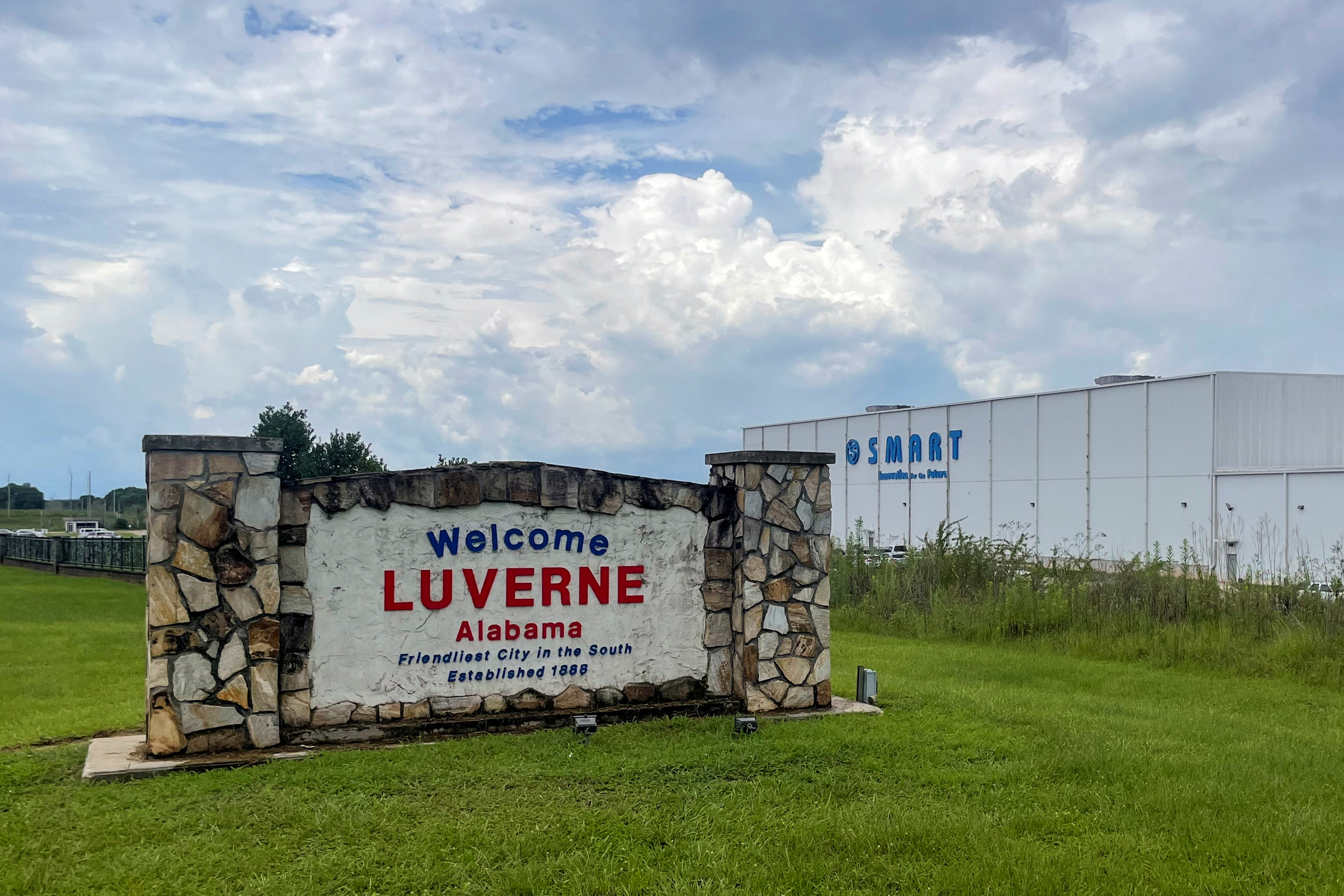 A welcome sign stands next to the SMART Alabama, LLC auto parts plant in Luverne