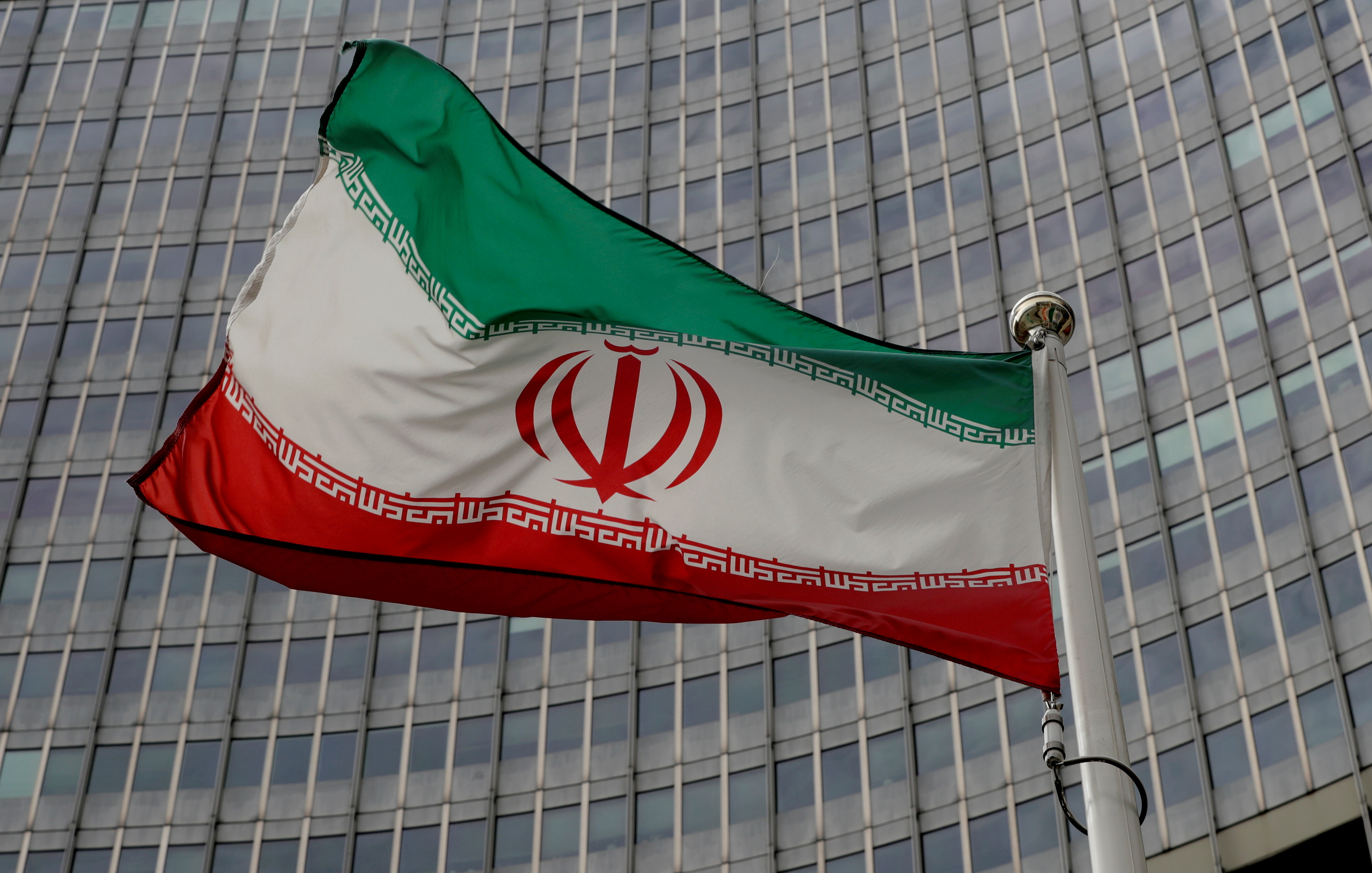 An Iranian flag flutters in front of the International Atomic Energy Agency (IAEA) headquarters in Vienna, Austria, September 9, 2019.   REUTERS/Leonhard Foeger/File Photo