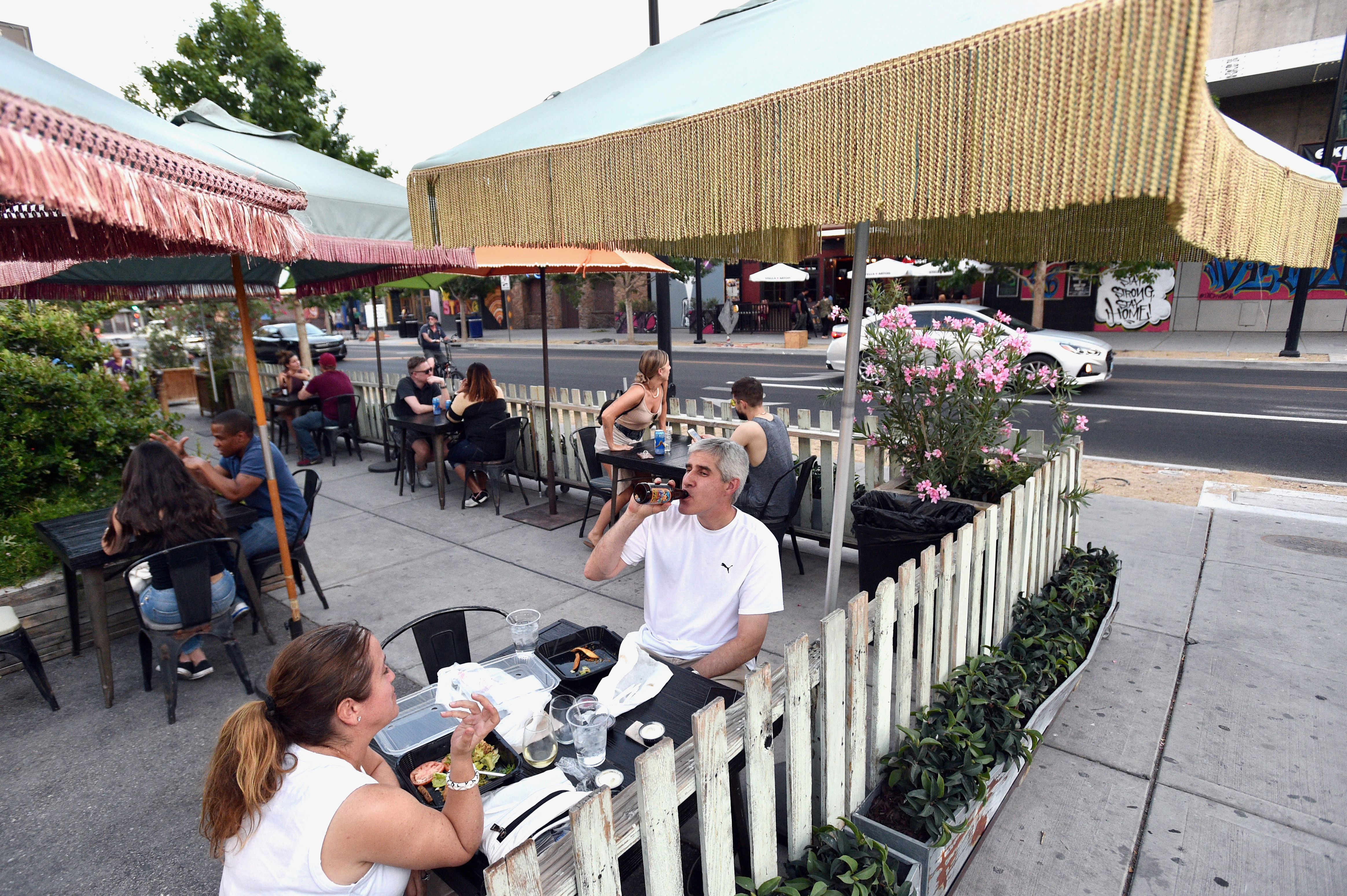 Cori Thune (L) and Phillip Thune dine outdoors at Park on Fremont as restaurants are opening for business on sidewalks as restrictions to prevent the spread of coronavirus disease (COVID-19) are eased in Las Vegas