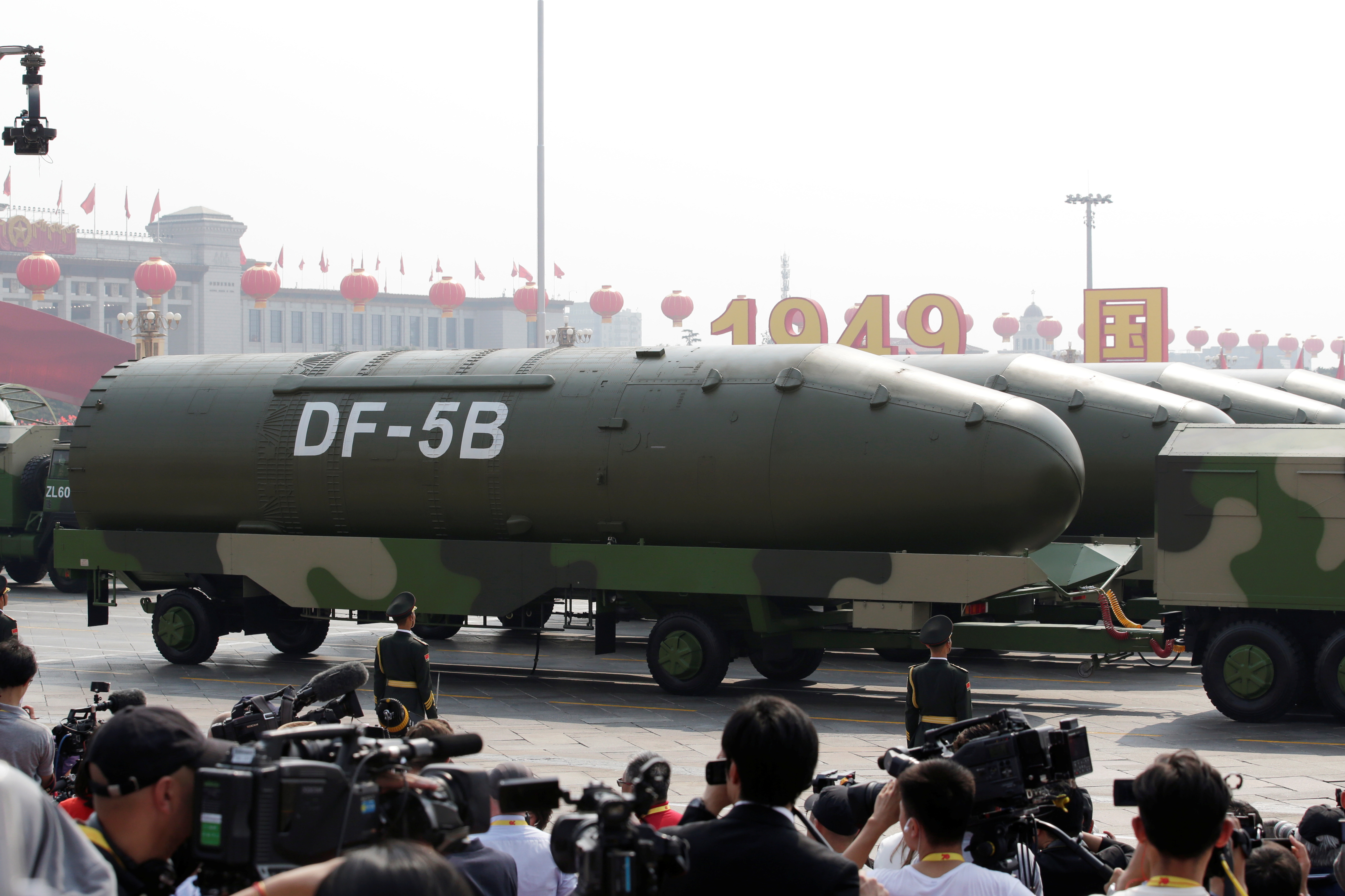 Military vehicles carrying DF-5B intercontinental ballistic missiles travel past Tiananmen Square during the military parade marking the 70th founding anniversary of People's Republic of China
