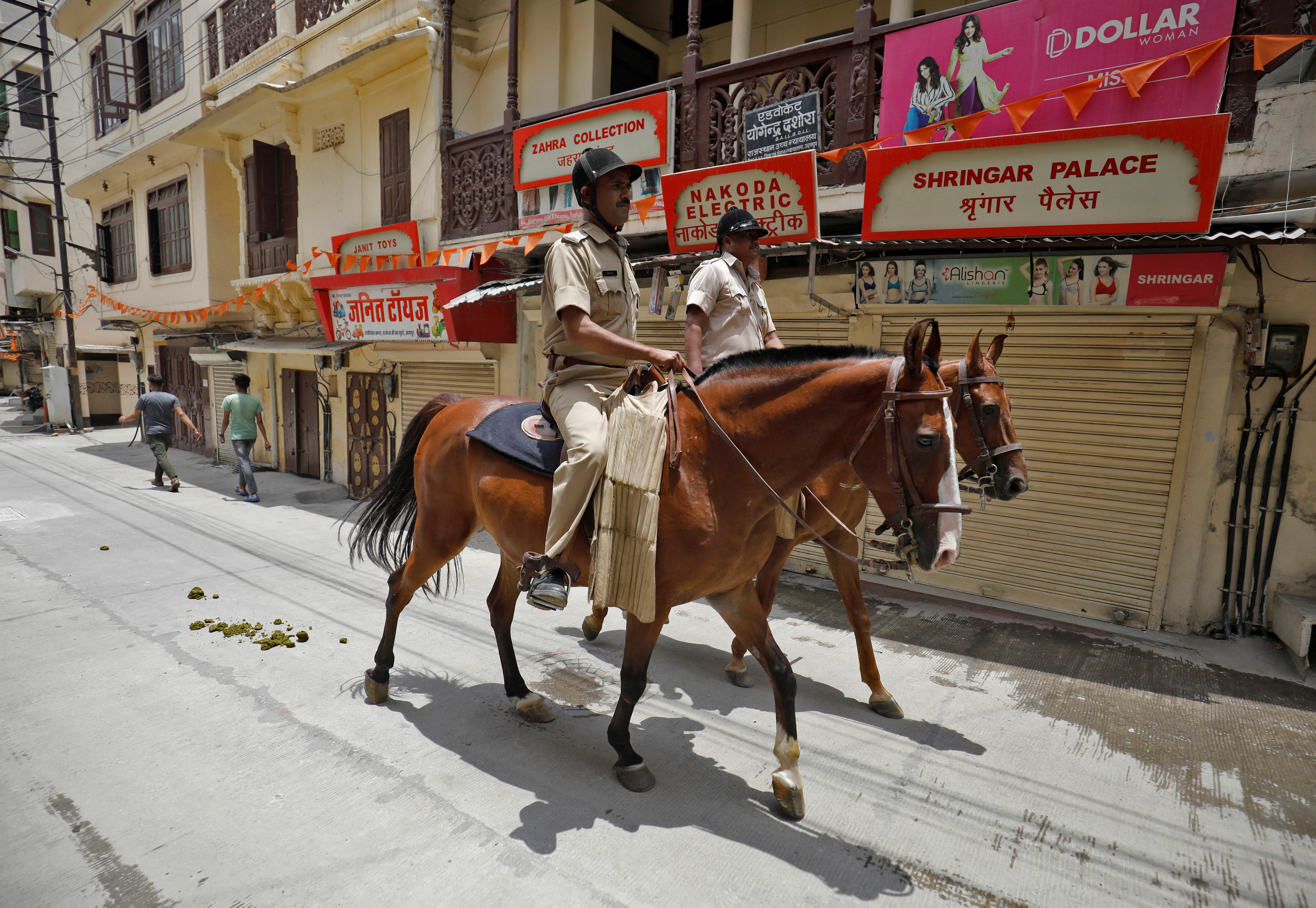 Policemen mounted on their horses patrol during restrictions imposed by authorities after the killing of Kanhaiya Lal Teli, a Hindu tailor, in Udaipur