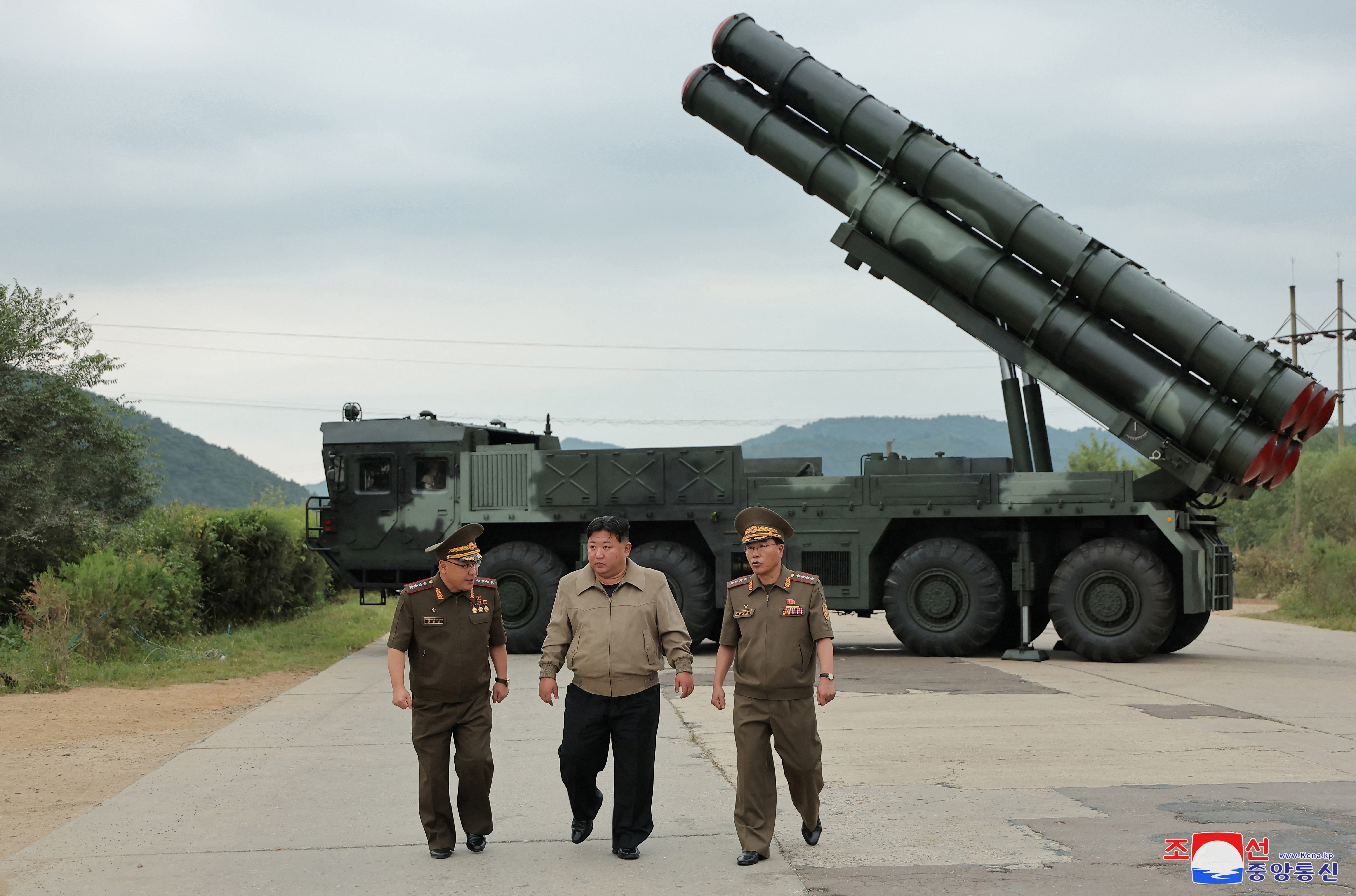 North Korean leader Kim Jong Un oversees a test-fire for a new 600mm multiple rocket launcher