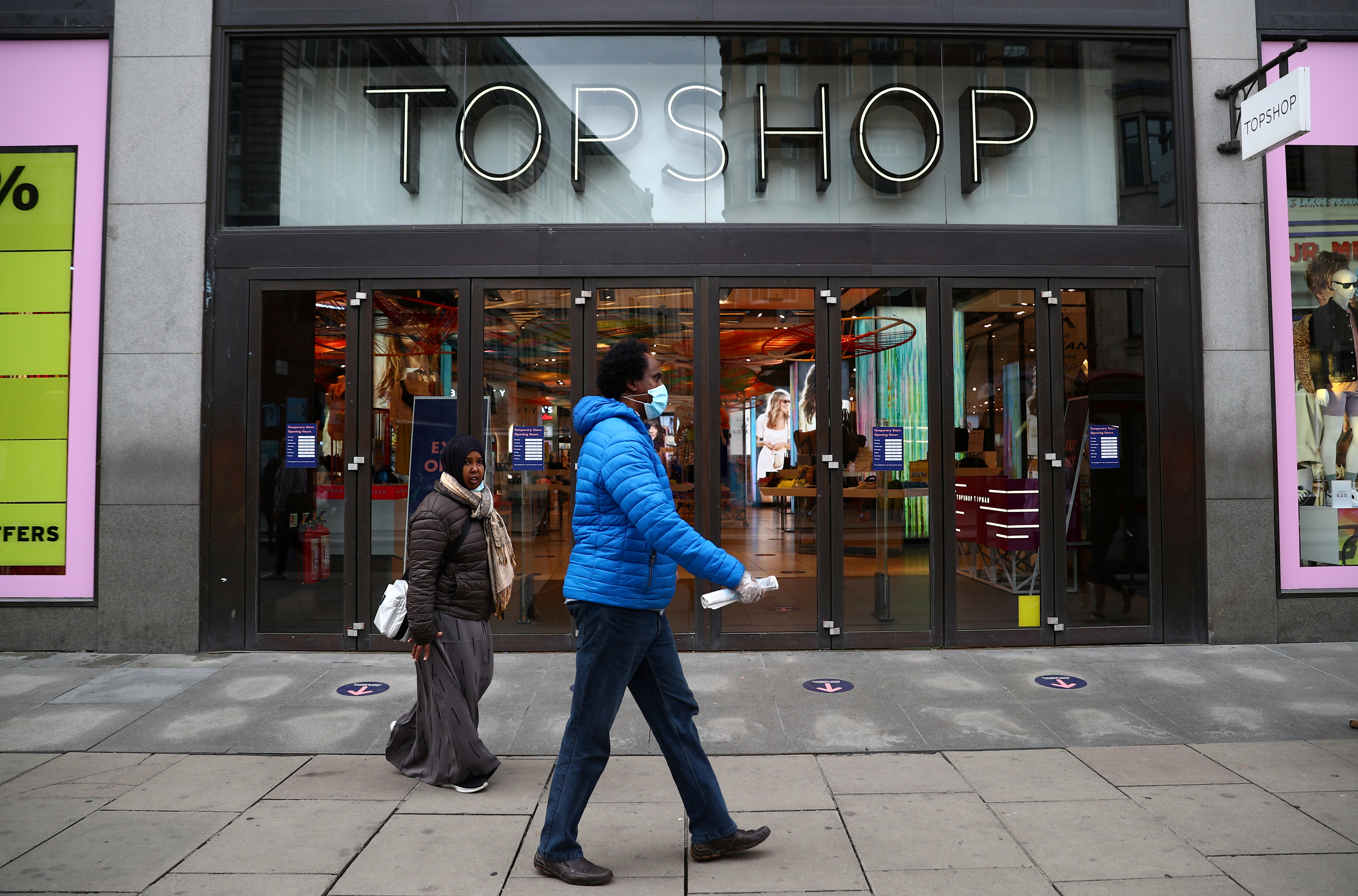 People walk past an entrance to the Topshop store at the Oxford Street, in London, Britain July 2, 2020. REUTERS/Hannah McKay