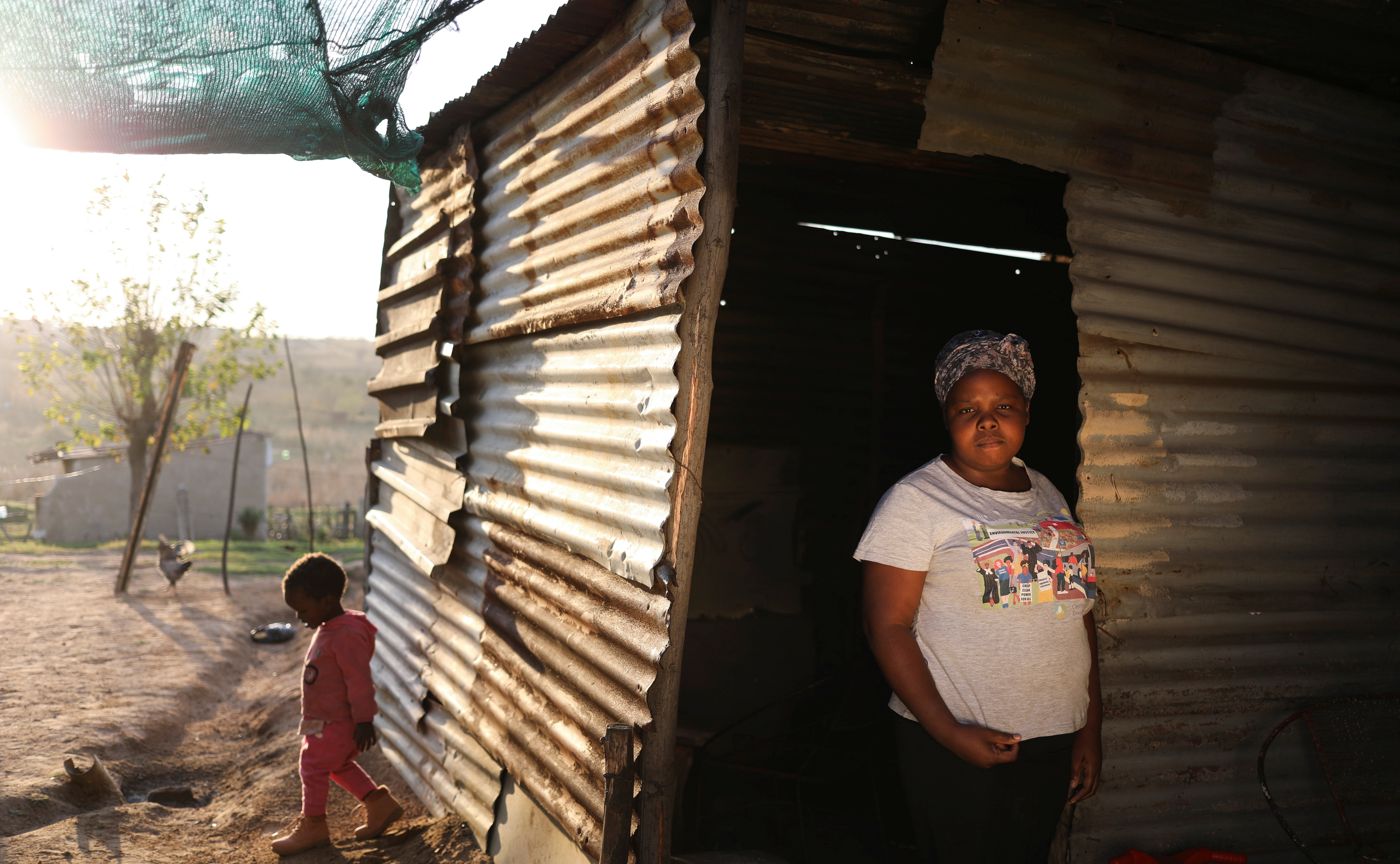 Mbali Matabule, poses for a photograph while her daughter Asemahle looks on at their home in Emalahleni, in Mpumalanga province, South Africa, June 2, 2021. REUTERS/Siphiwe Sibeko