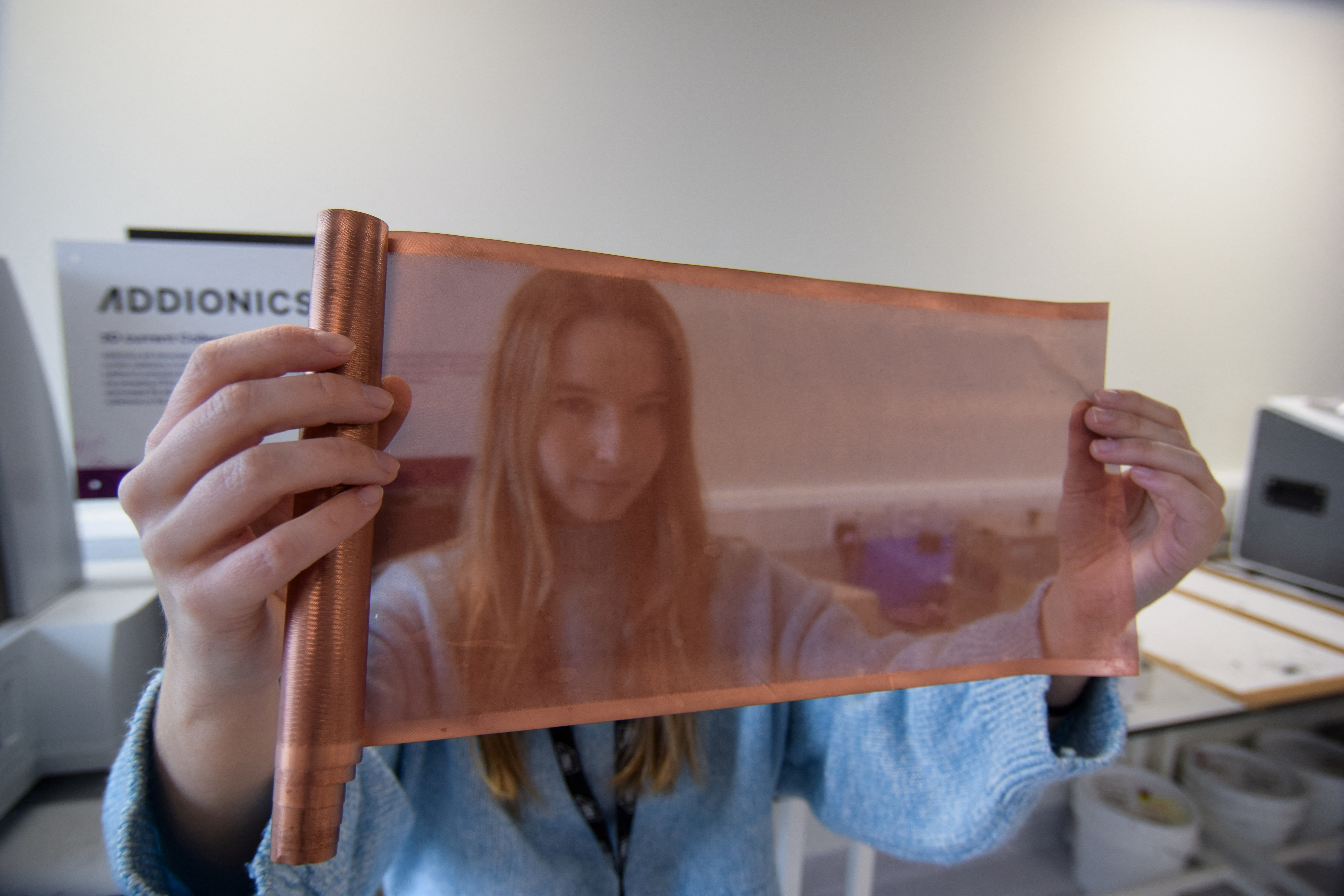 Bernadett Vejkey, marketing manager at Addionics, holds up a sheet of a porous, three-dimensional copper anode, in London