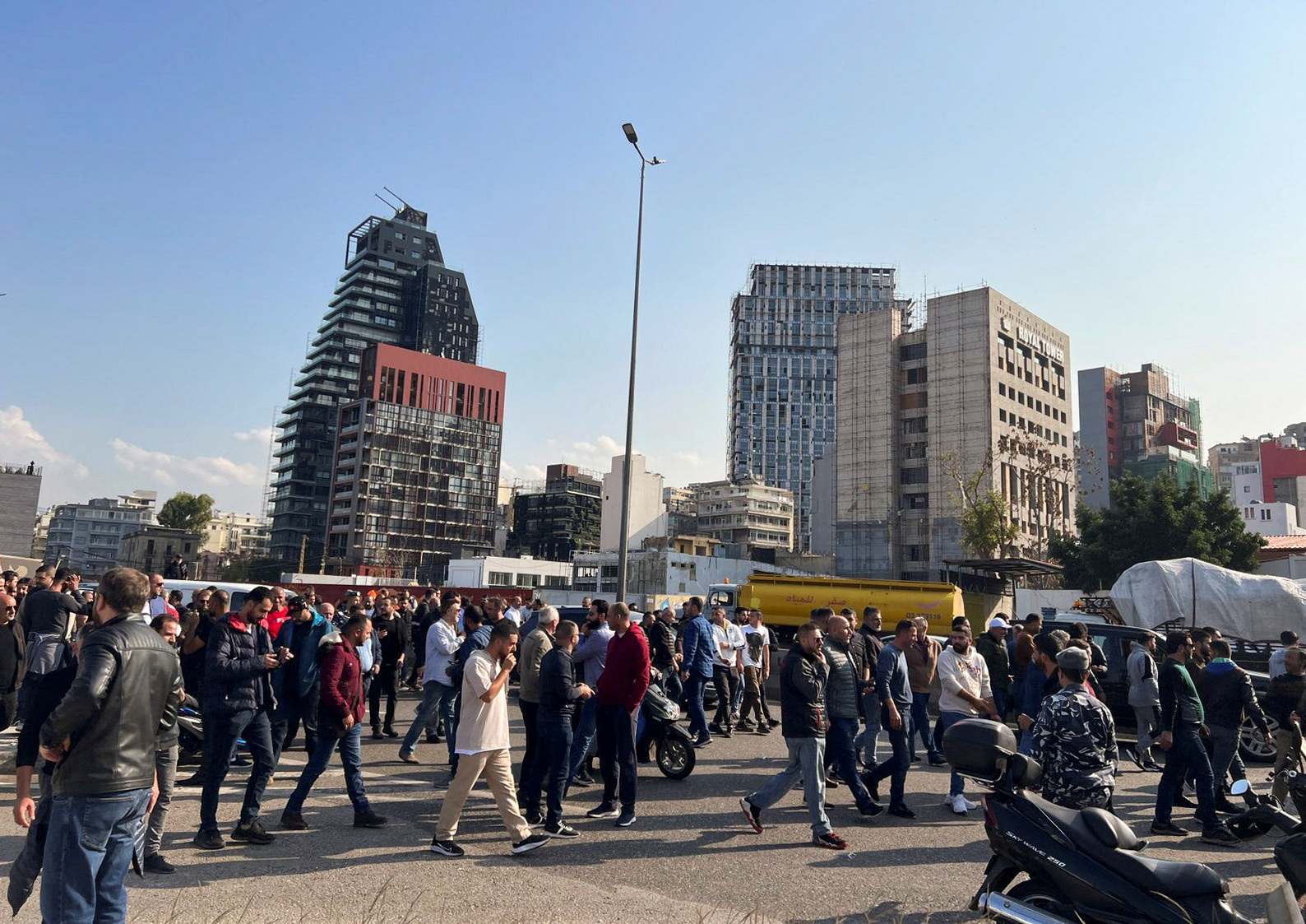 Owners of car dealerships block a road during a protest against tariff hikes in Beirut