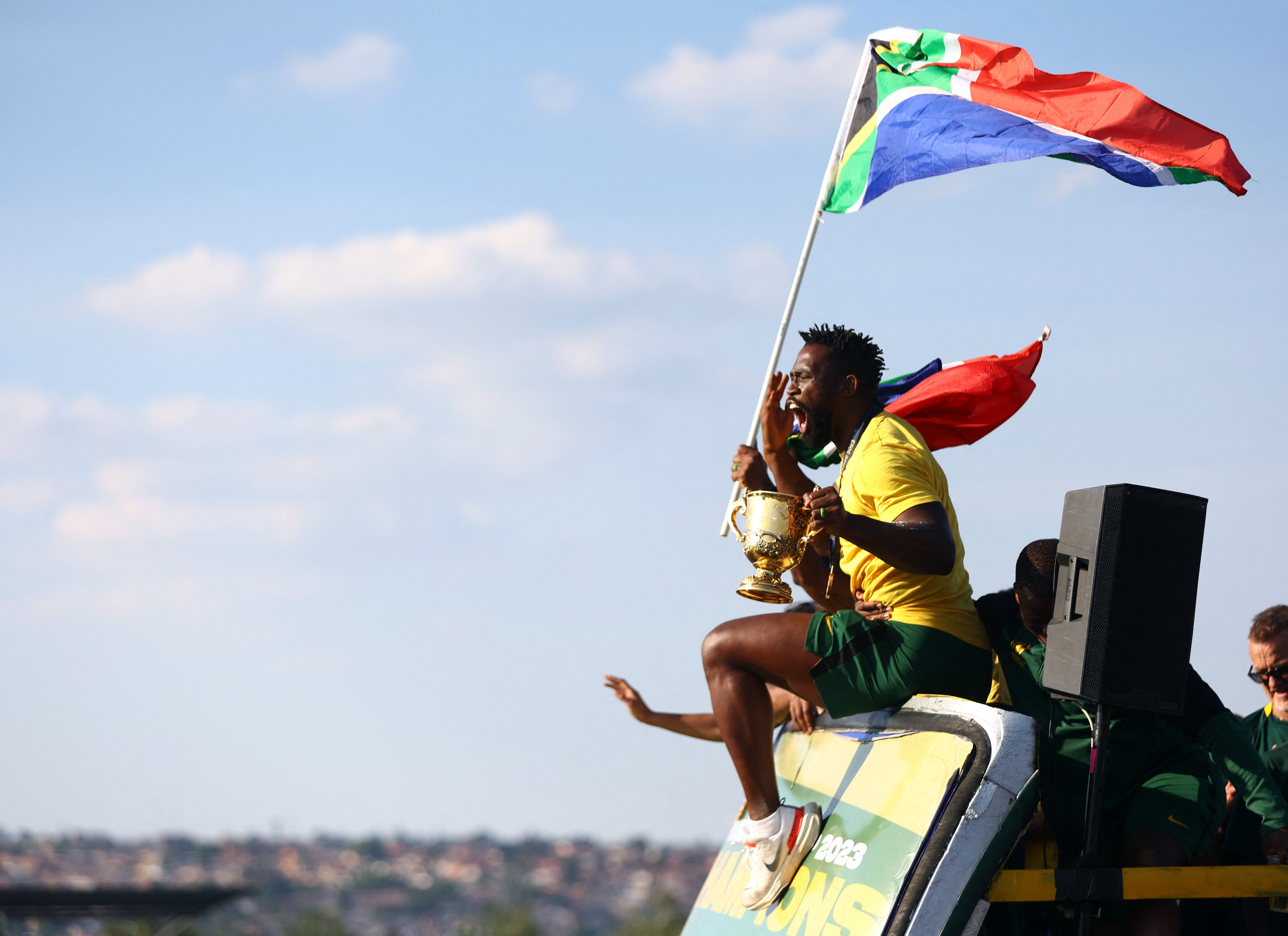 White South African man holds up a flag for the Afrikaner