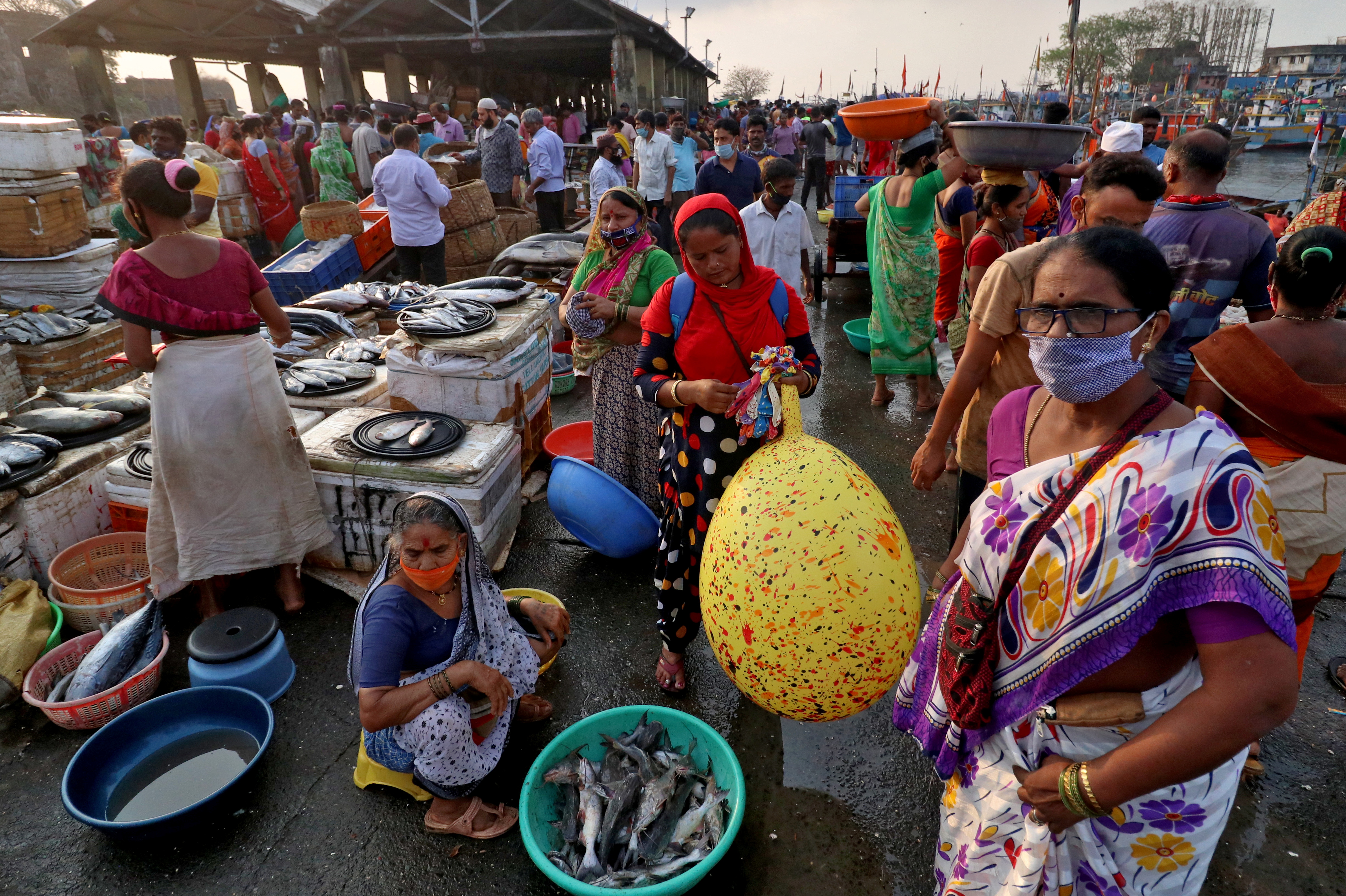 People are seen at a fish market, amidst the spread of the coronavirus disease (COVID-19), in Mumbai