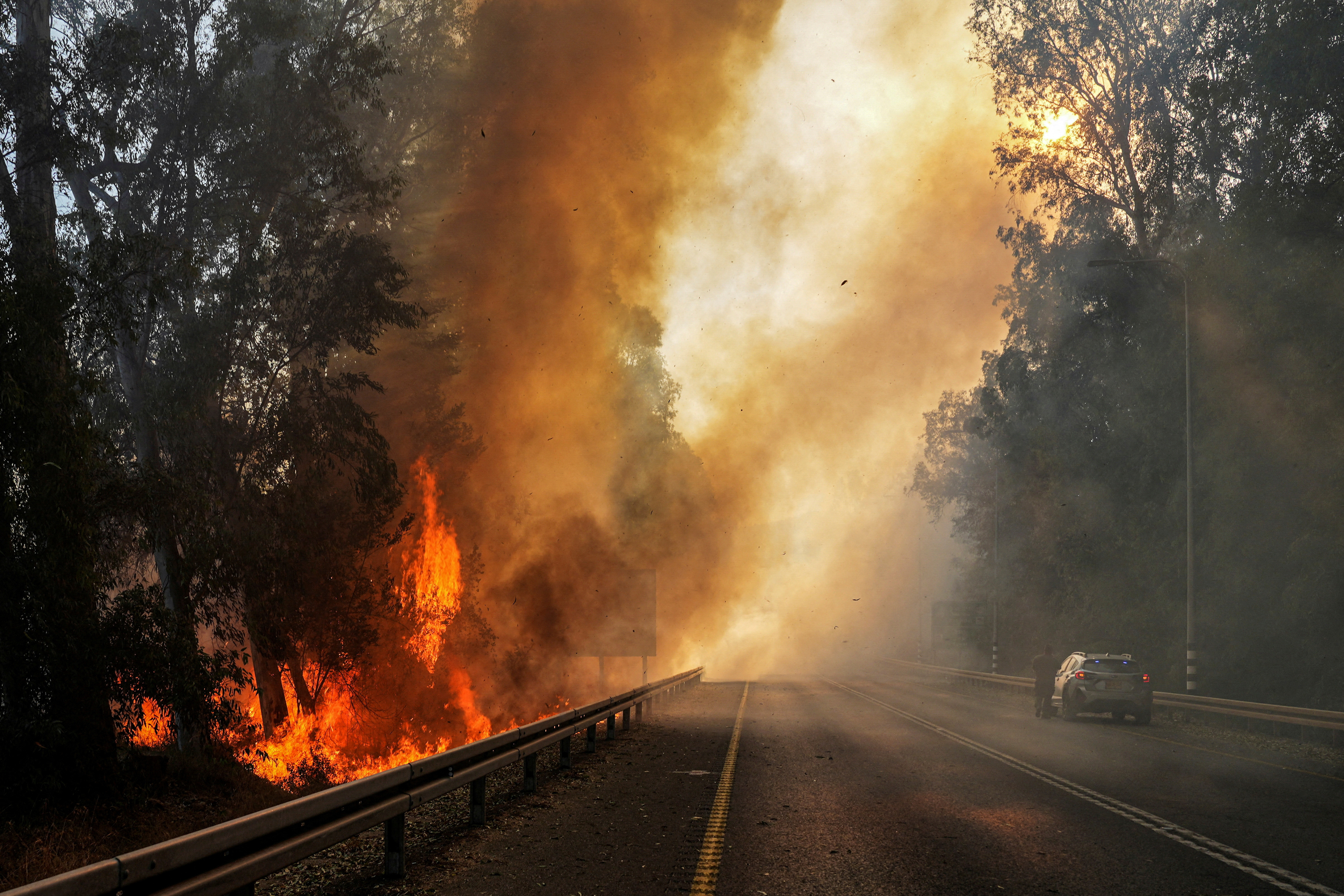 Flames seen at the side of a road, amid ongoing cross-border hostilities between Hezbollah and Israeli forces, close to the Israel border with Lebanon