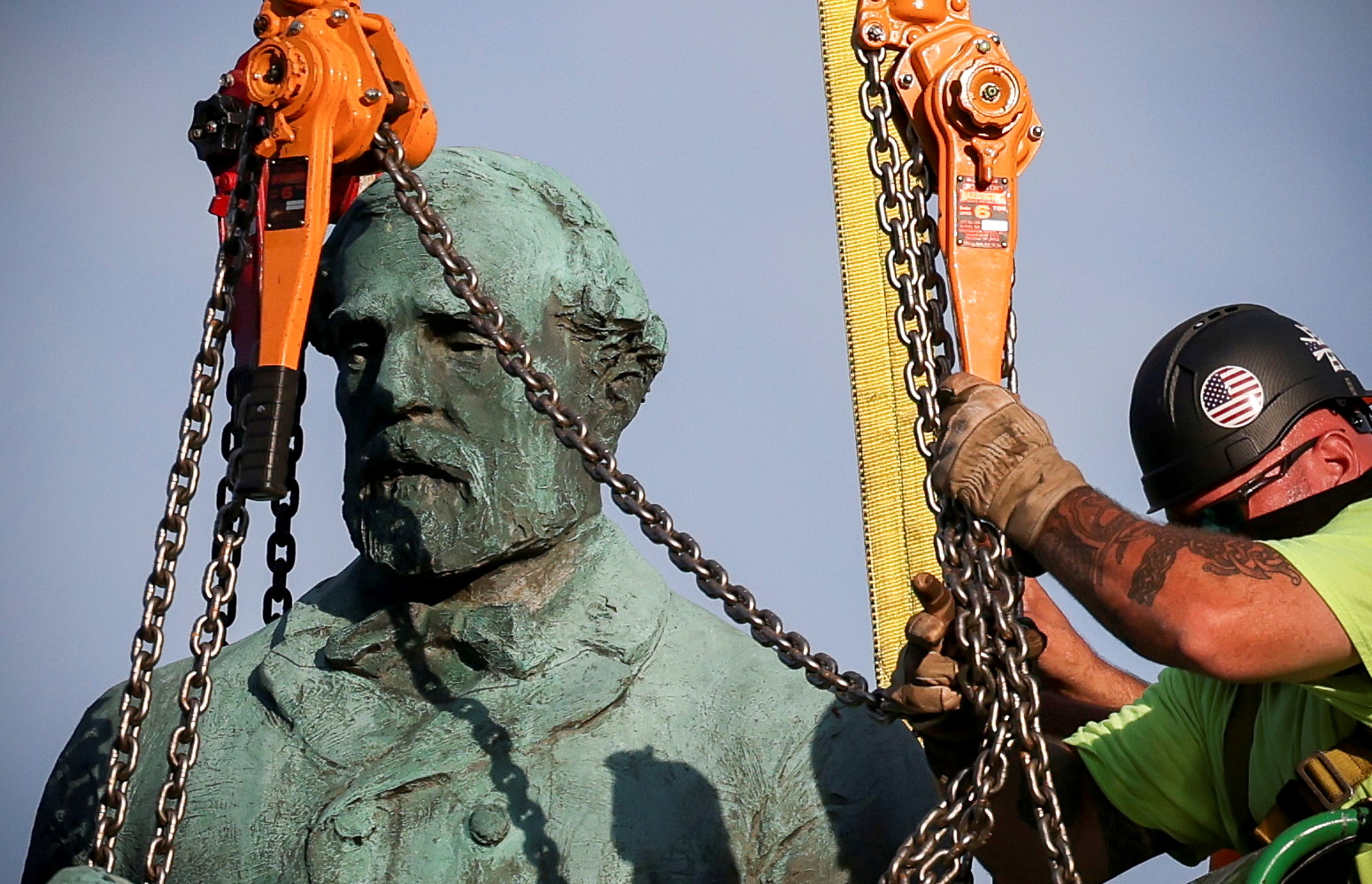Workers remove a statue of Confederate General Robert E. Lee, in Charlottesville