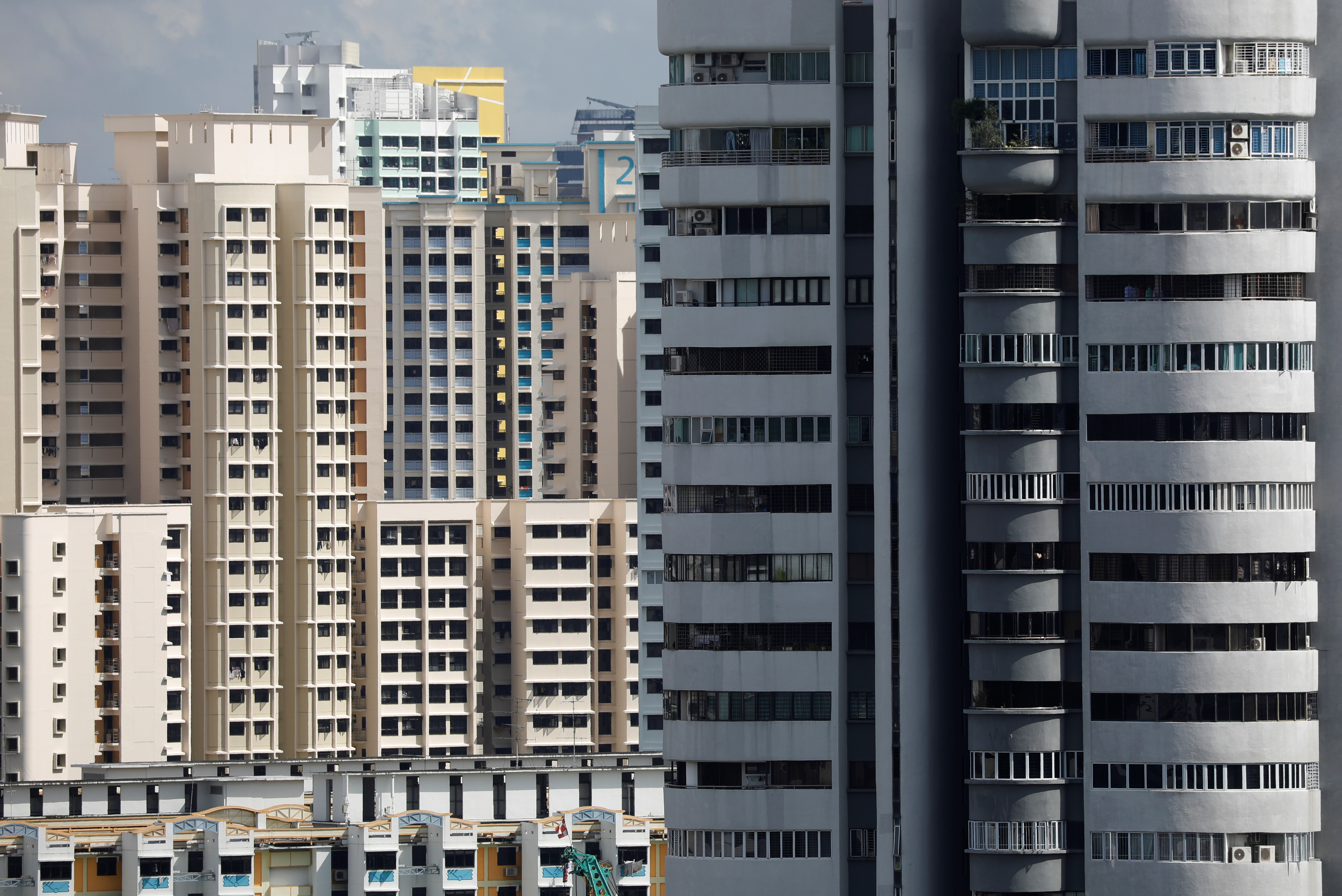 A view of a private residential condominium in front of public housing estates in Singapore