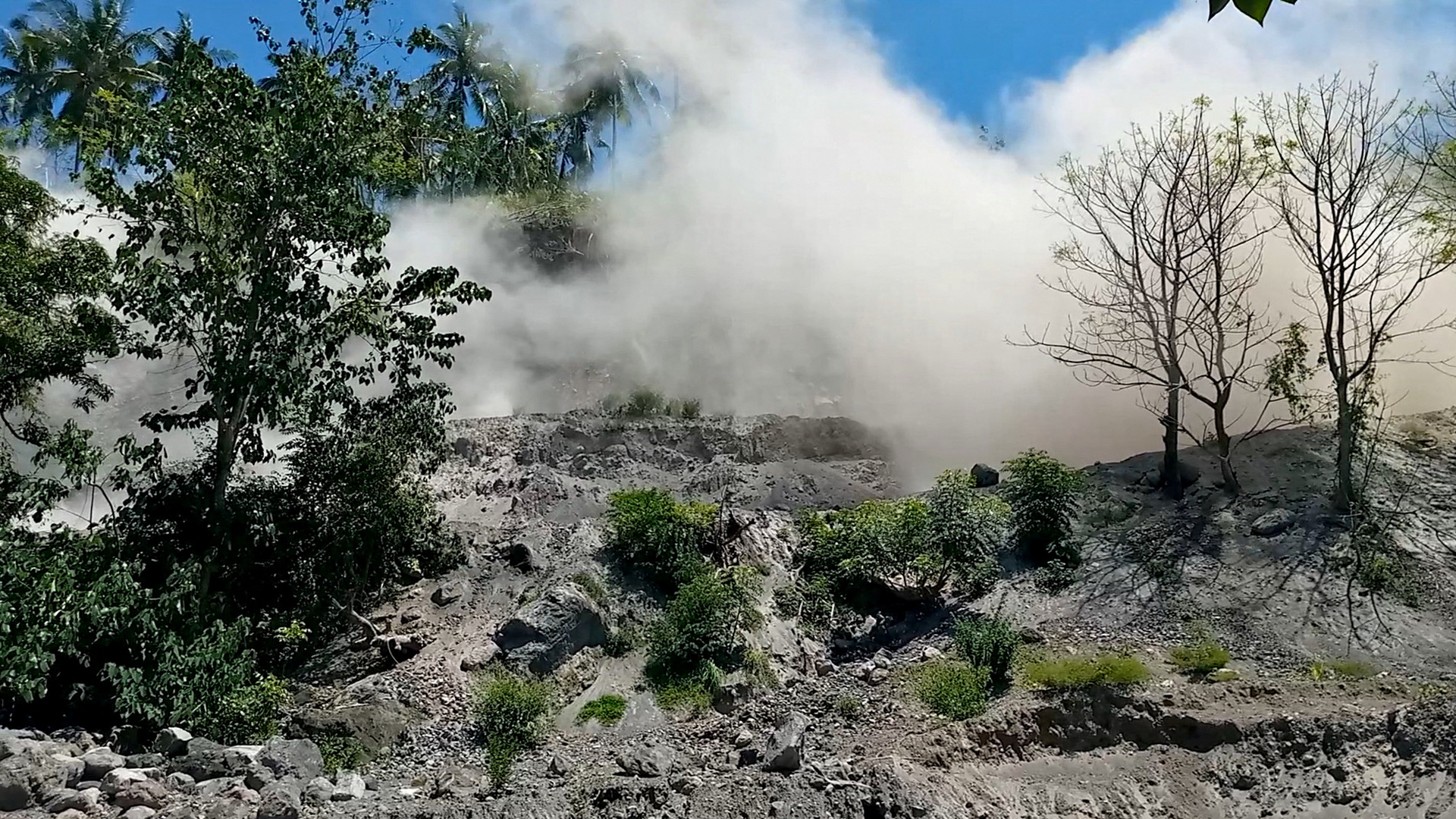 A still image from a social media video shows dust disturbances on side of hill after an earthquake in Nagekeo, East Nusa Tenggara, Indonesia December 14, 2021.   Alldo Van Robby/via REUTERS   