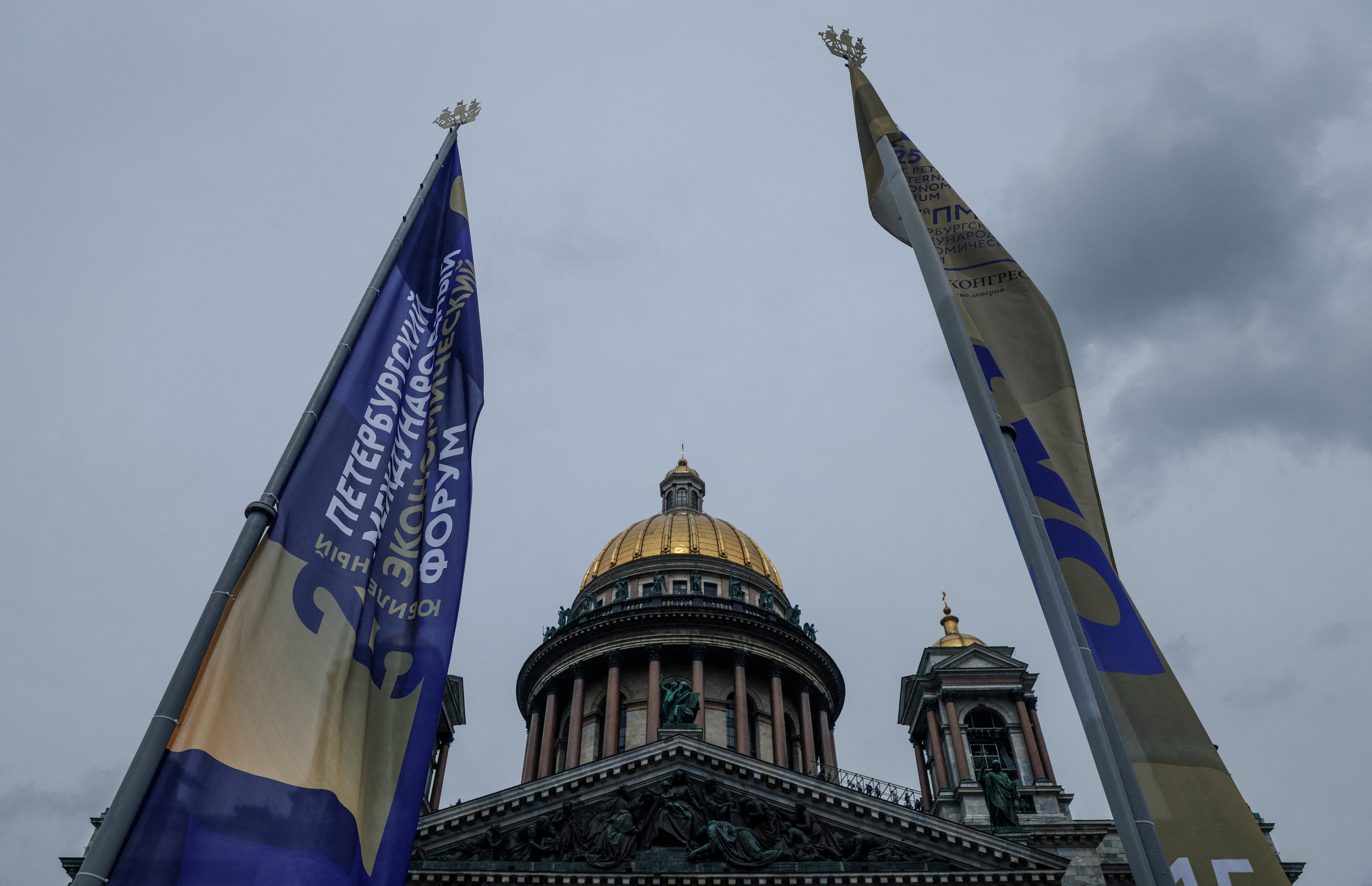 Flags with the St. Petersburg International Economic Forum (SPIEF) logo fly near the St. Isaac's Cathedral in Saint Petersburg